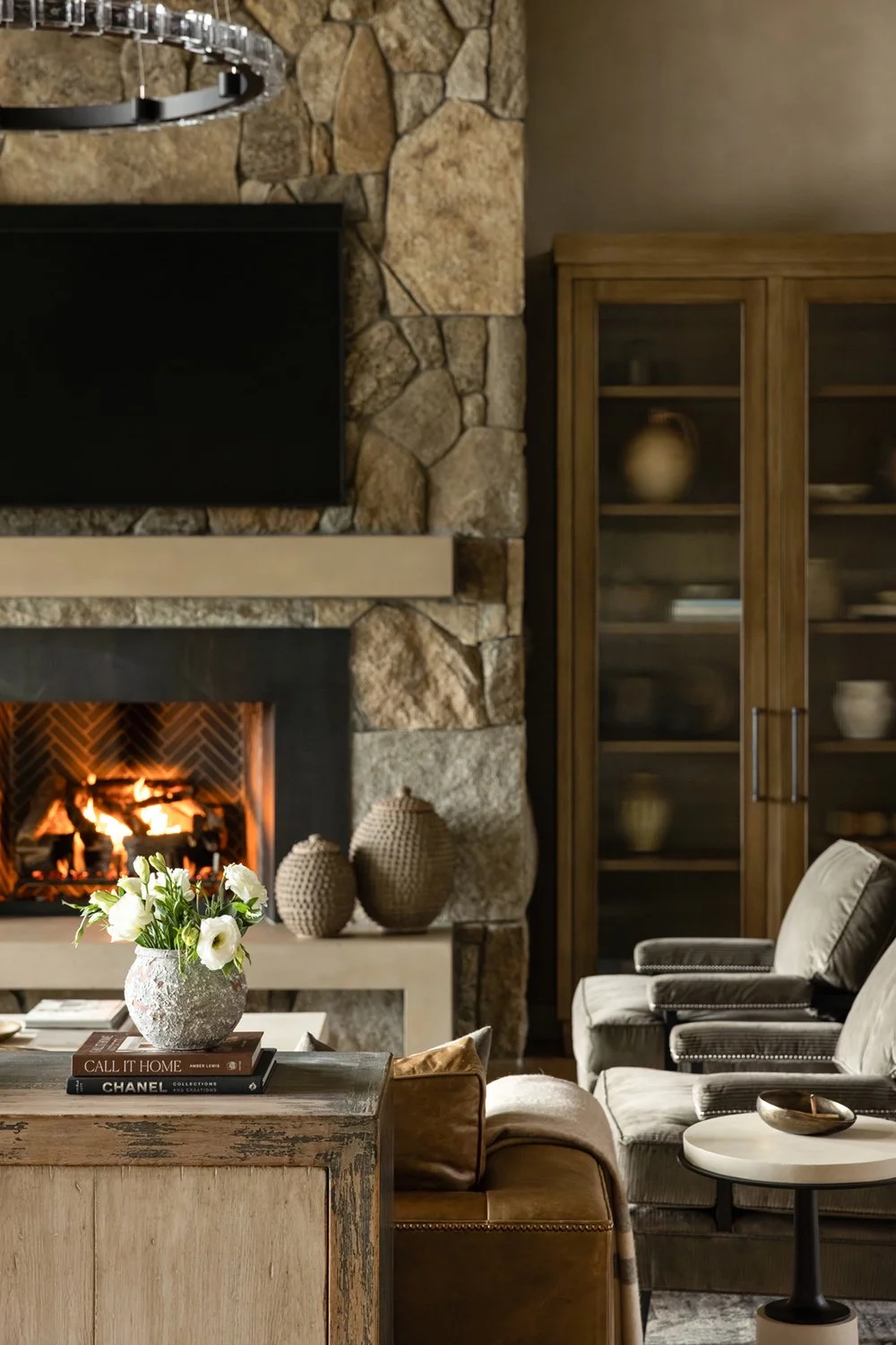 living room with stone fireplace