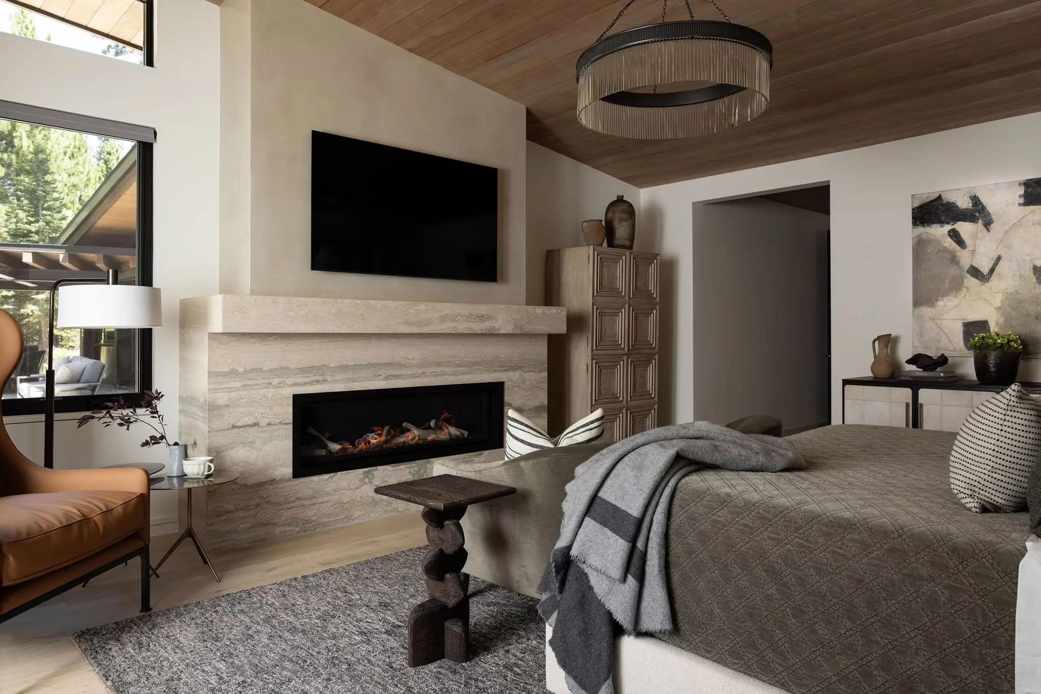 master bedroom with fireplace and tv