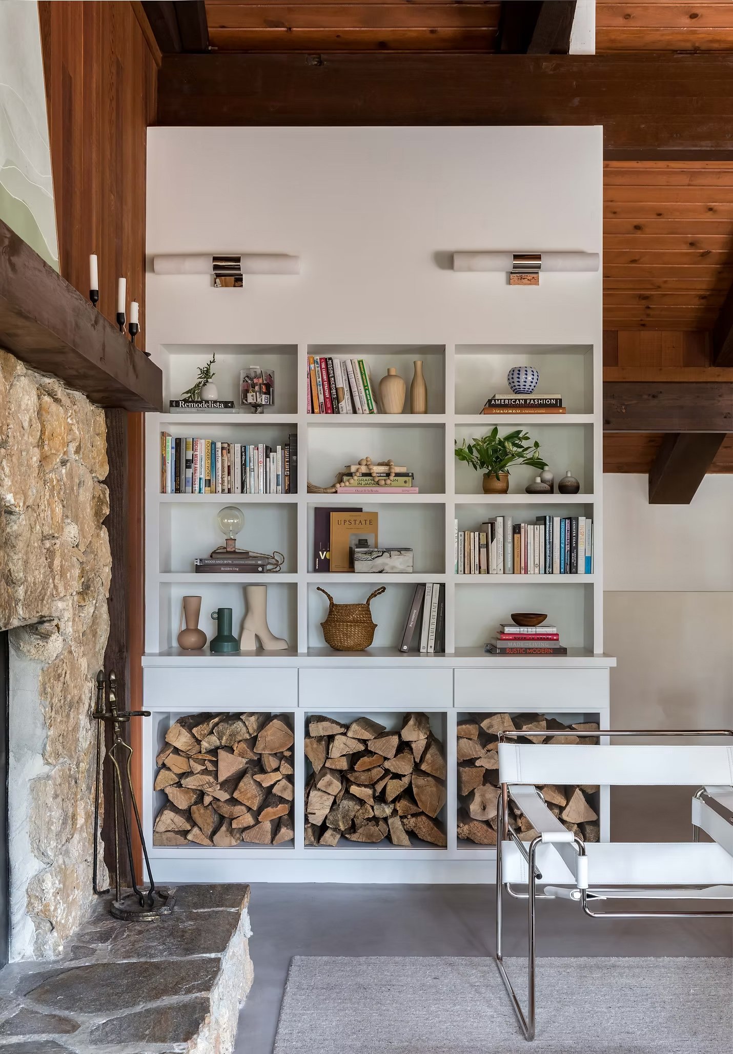 shelving with firewood and books and decor