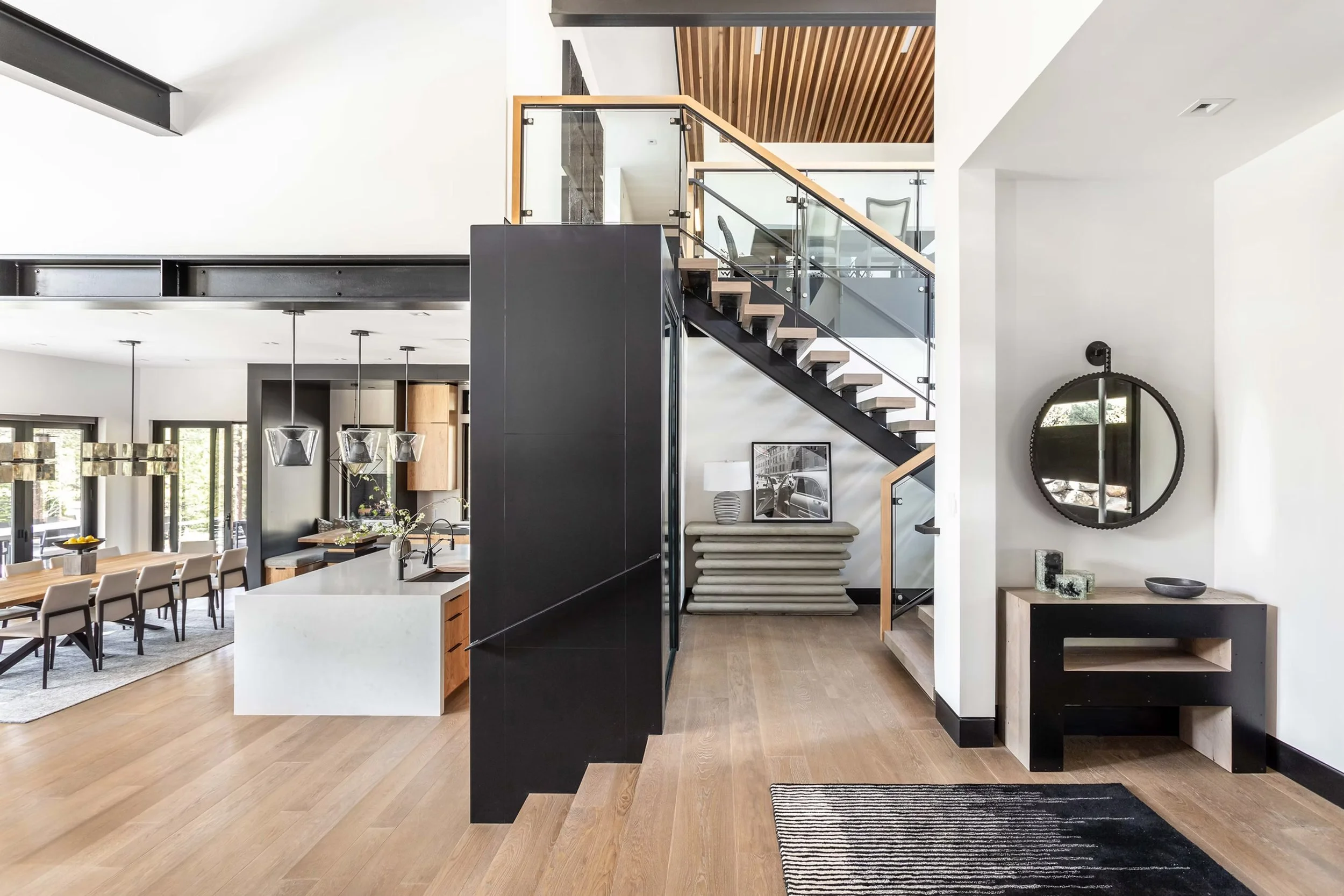 view of dining room, kitchen, staircase, and entry