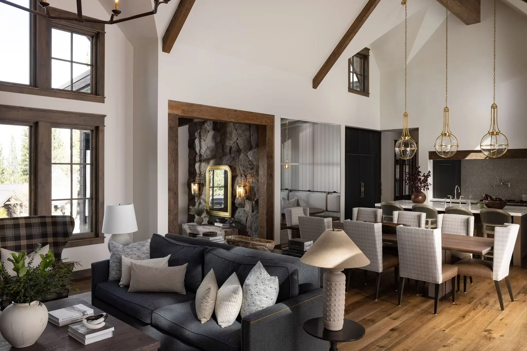 living room into dining room into kitchen with tall vaulted ceilings