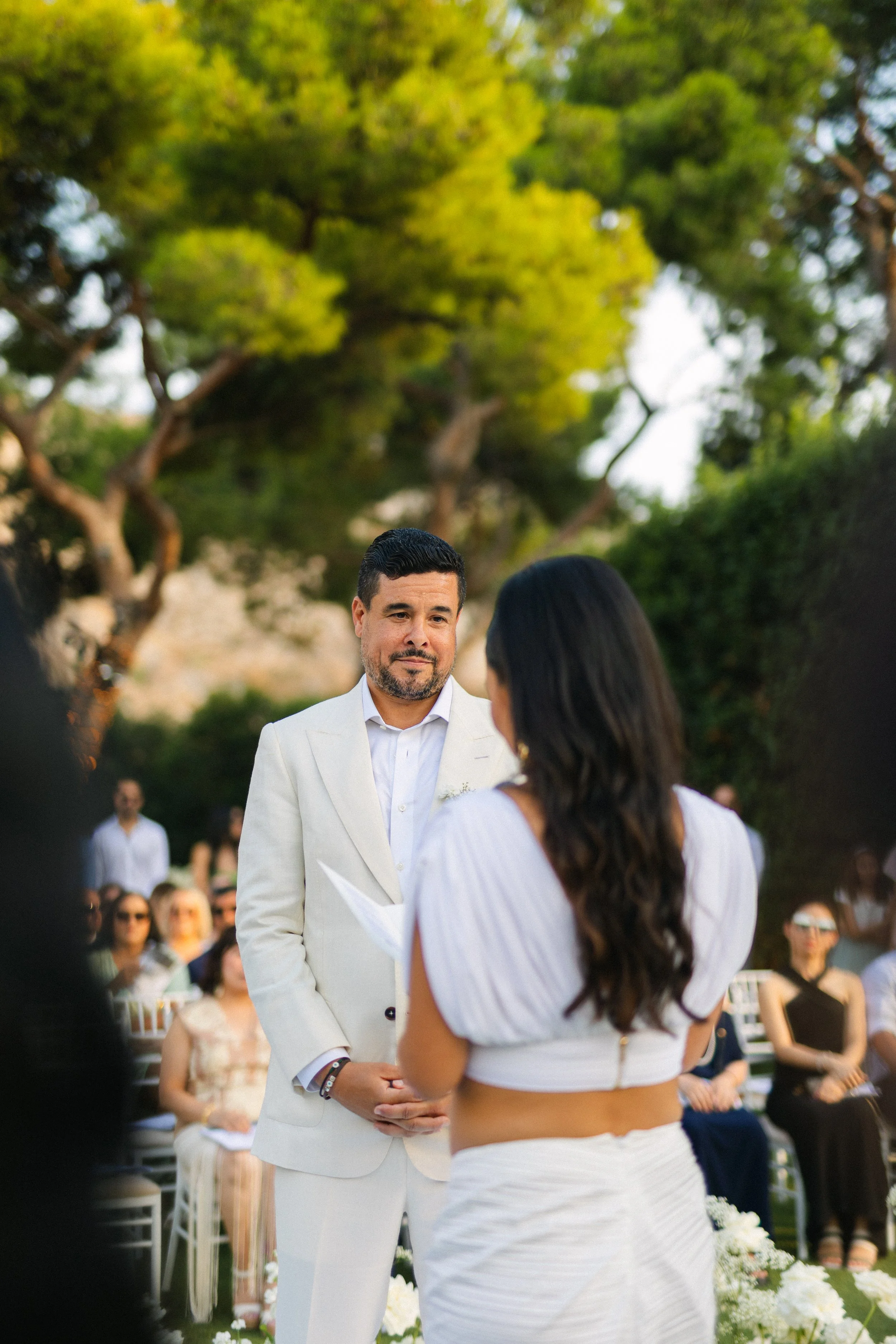 Emotional ceremony moment Lake Vouliagmeni Greece wedding