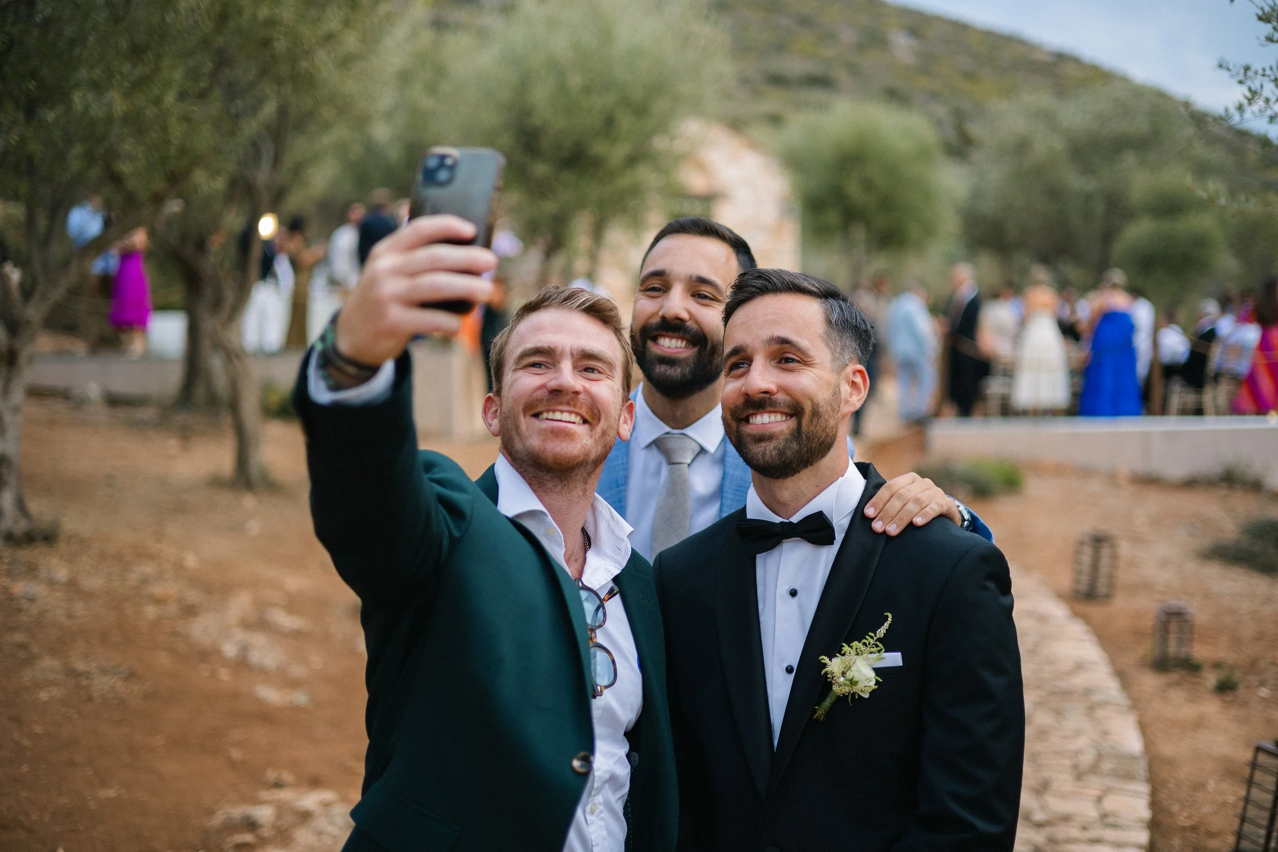 Groom laughing with friends Iliou Petra estate Athens wedding