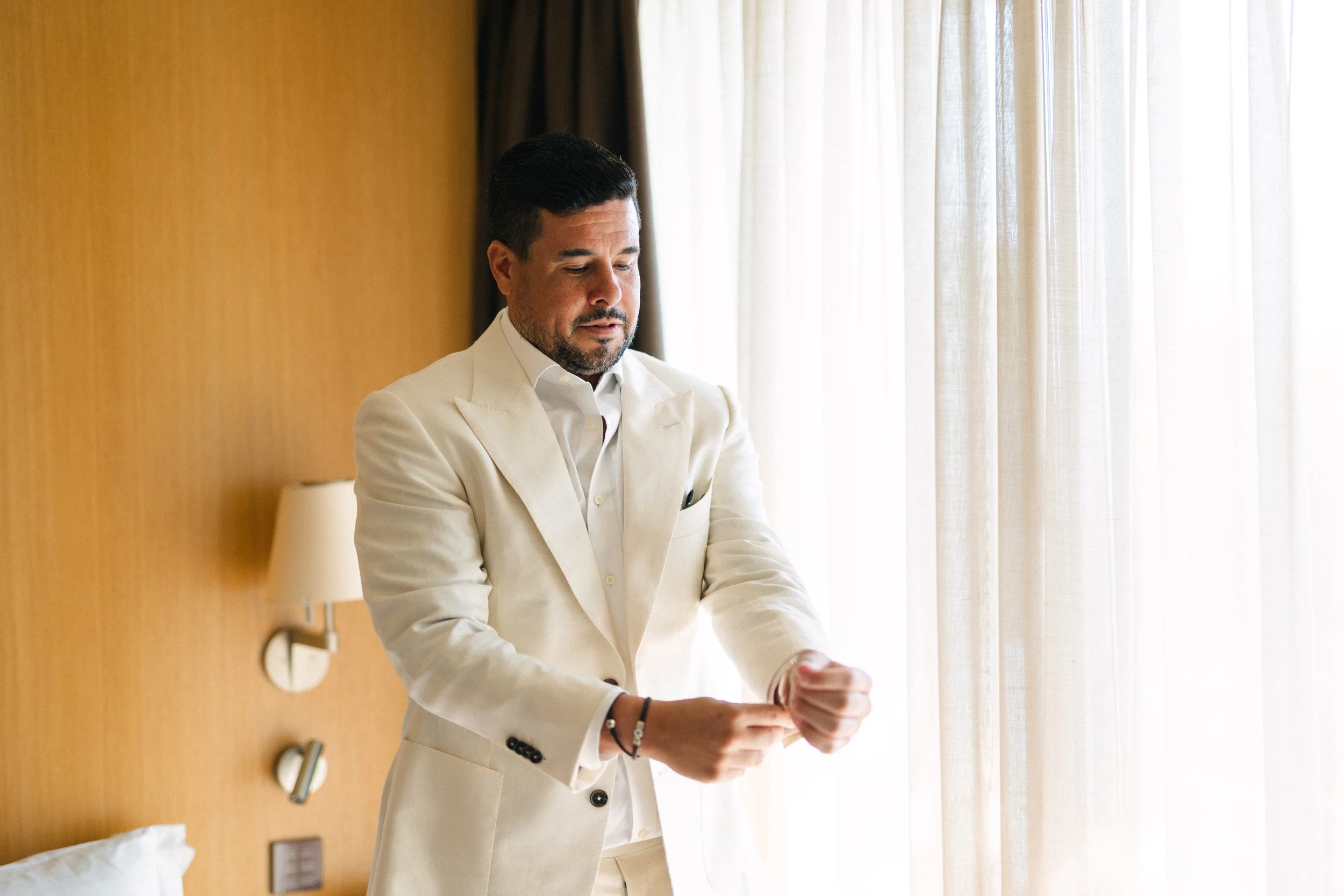 Groom getting ready Lake Vouliagmeni Athens Greece