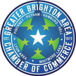 Circular logo for Greater Brighton Area Chamber of Commerce with blue background, white and green stars, and text listing cities and the establishment year 1972.