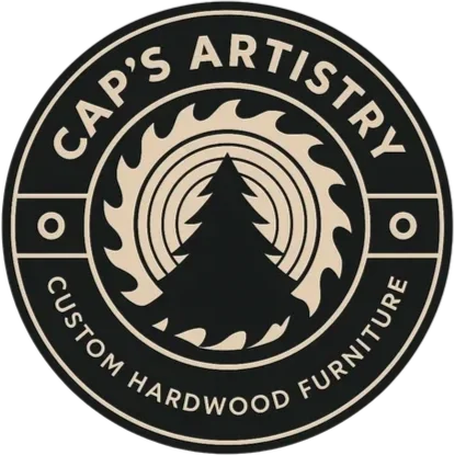 Logo for Cap's Artistry, a custom hardwood furniture company, featuring a tree with a sunburst design in the background.