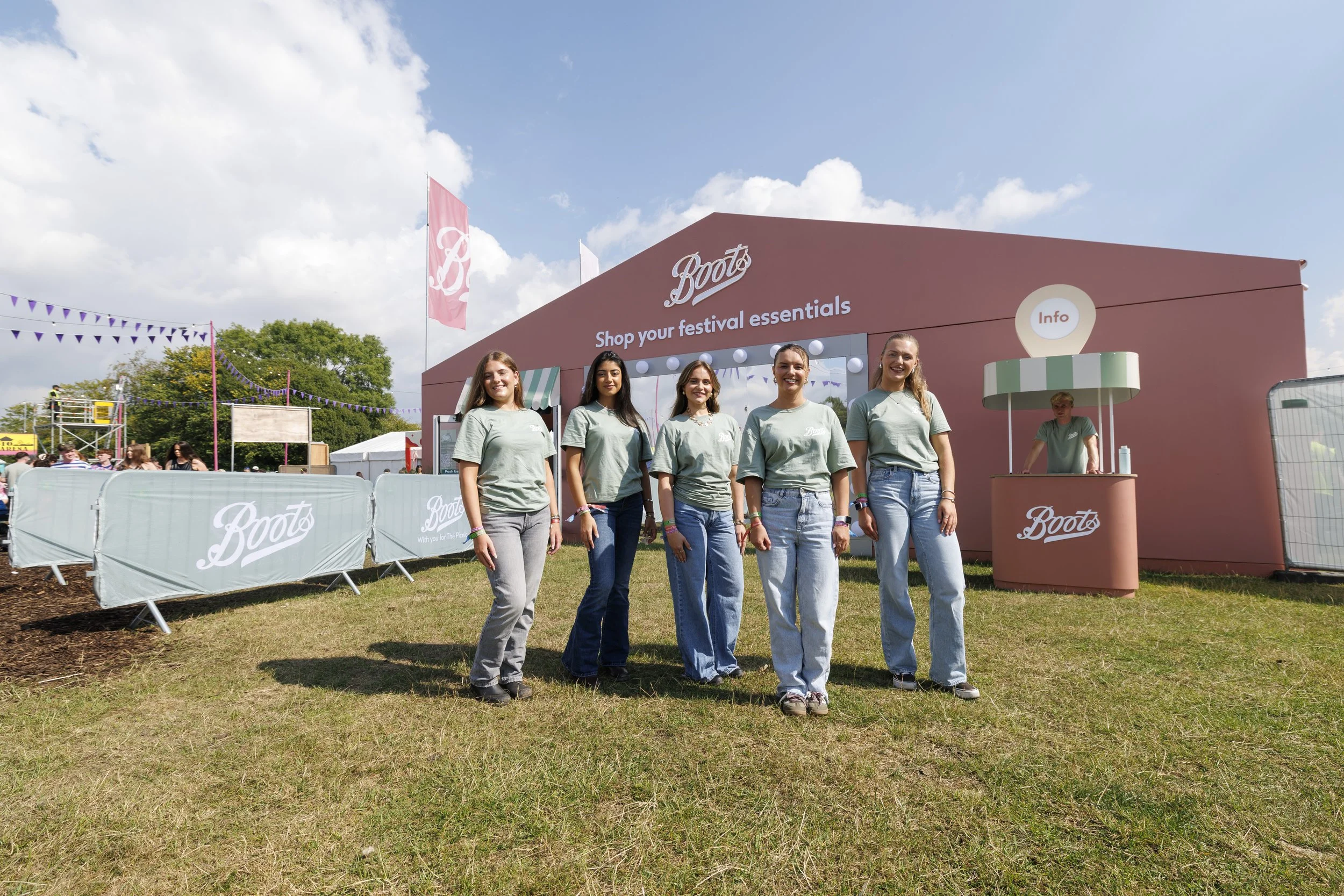 Boots Festival Store at Electric Picnic 2026 ."Shop your festival essentials" and the Boot's logo. The women are smiling and wearing light green t-shirts.