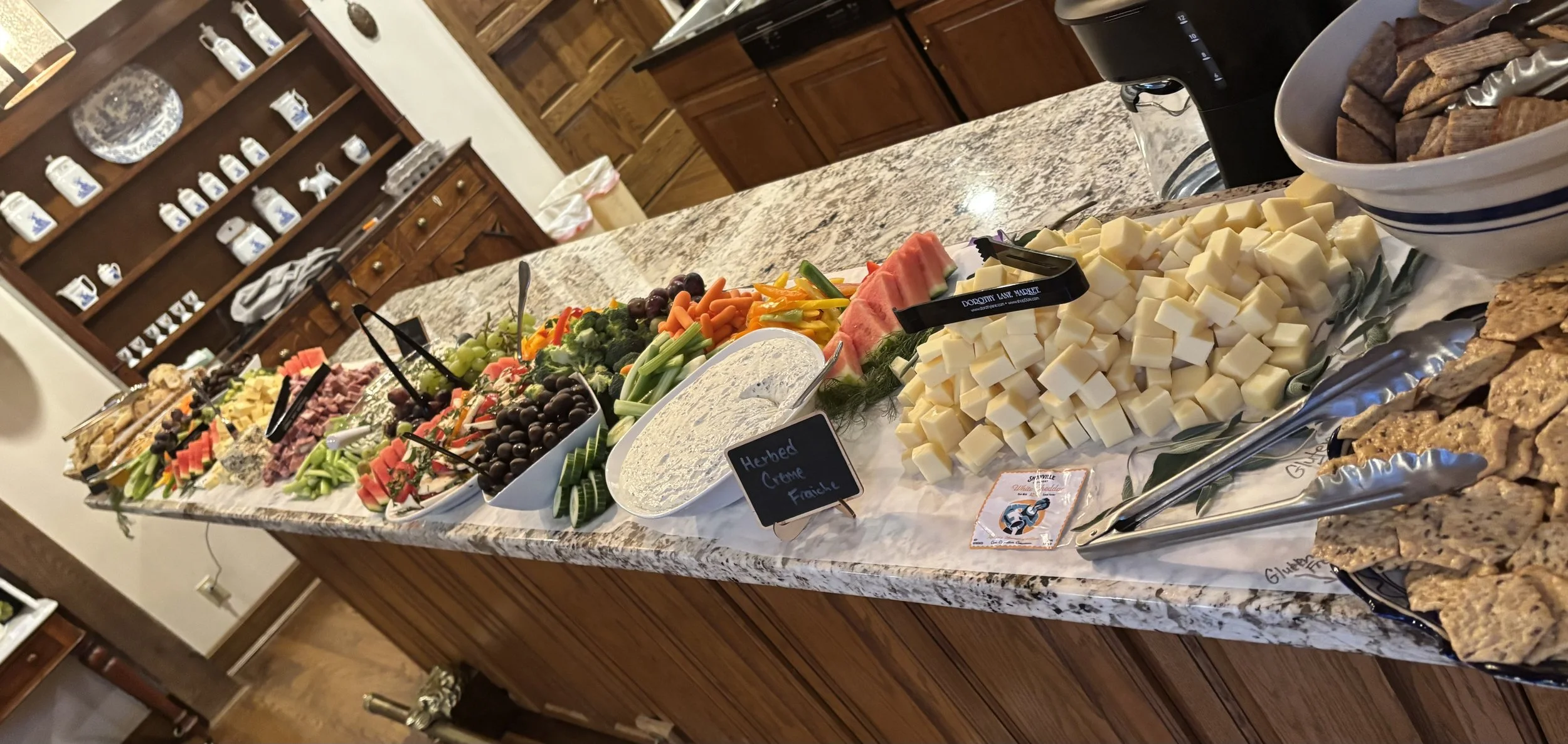 Dips, cheeses, fruit and veg displayed on the bar in the kitchen