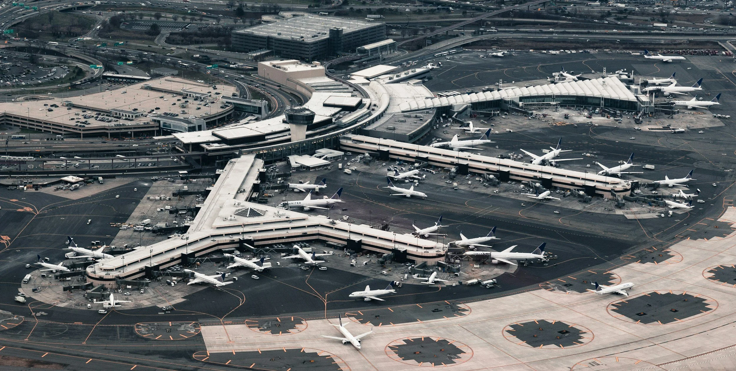 Busy international airport terminal viewed from above. Airplanes taxiing.