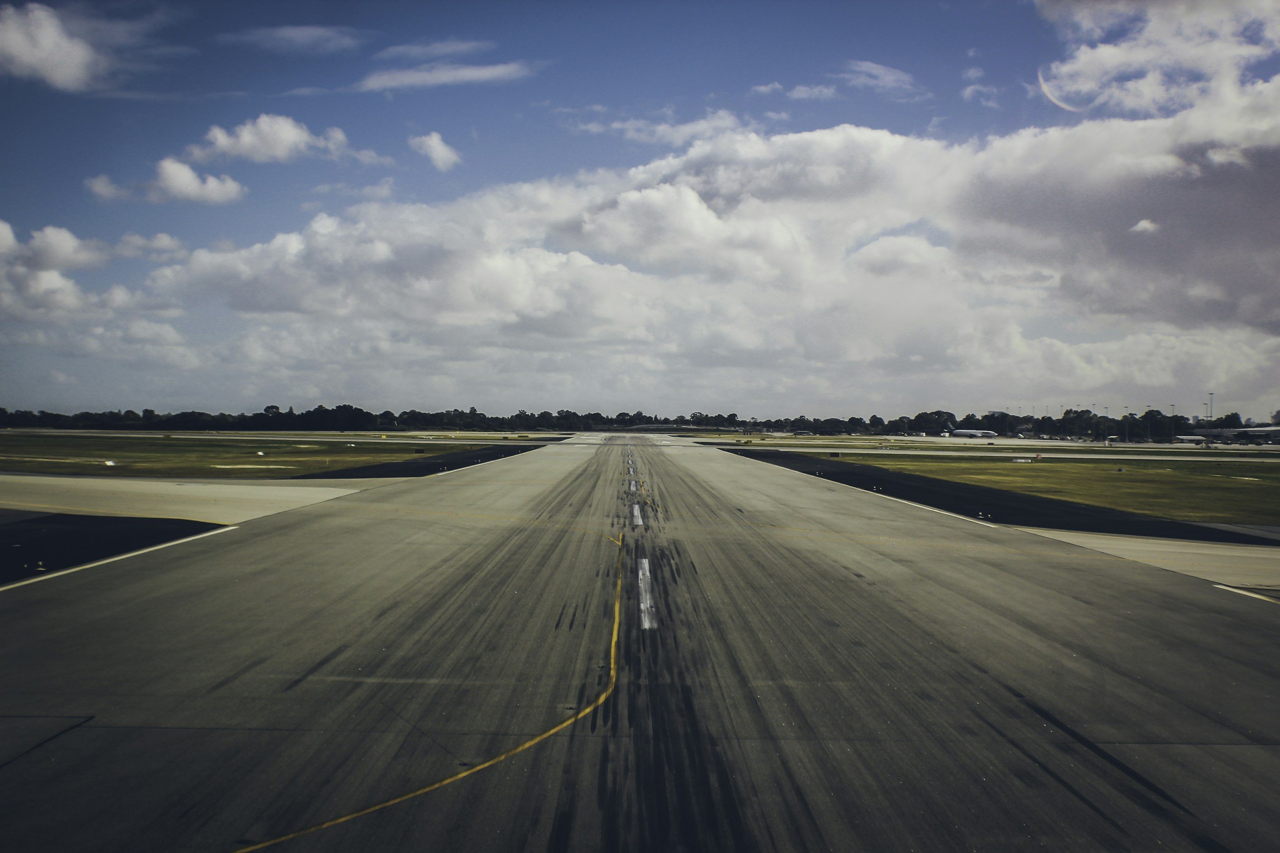 A view of a runway just before takeoff, sunny skies.