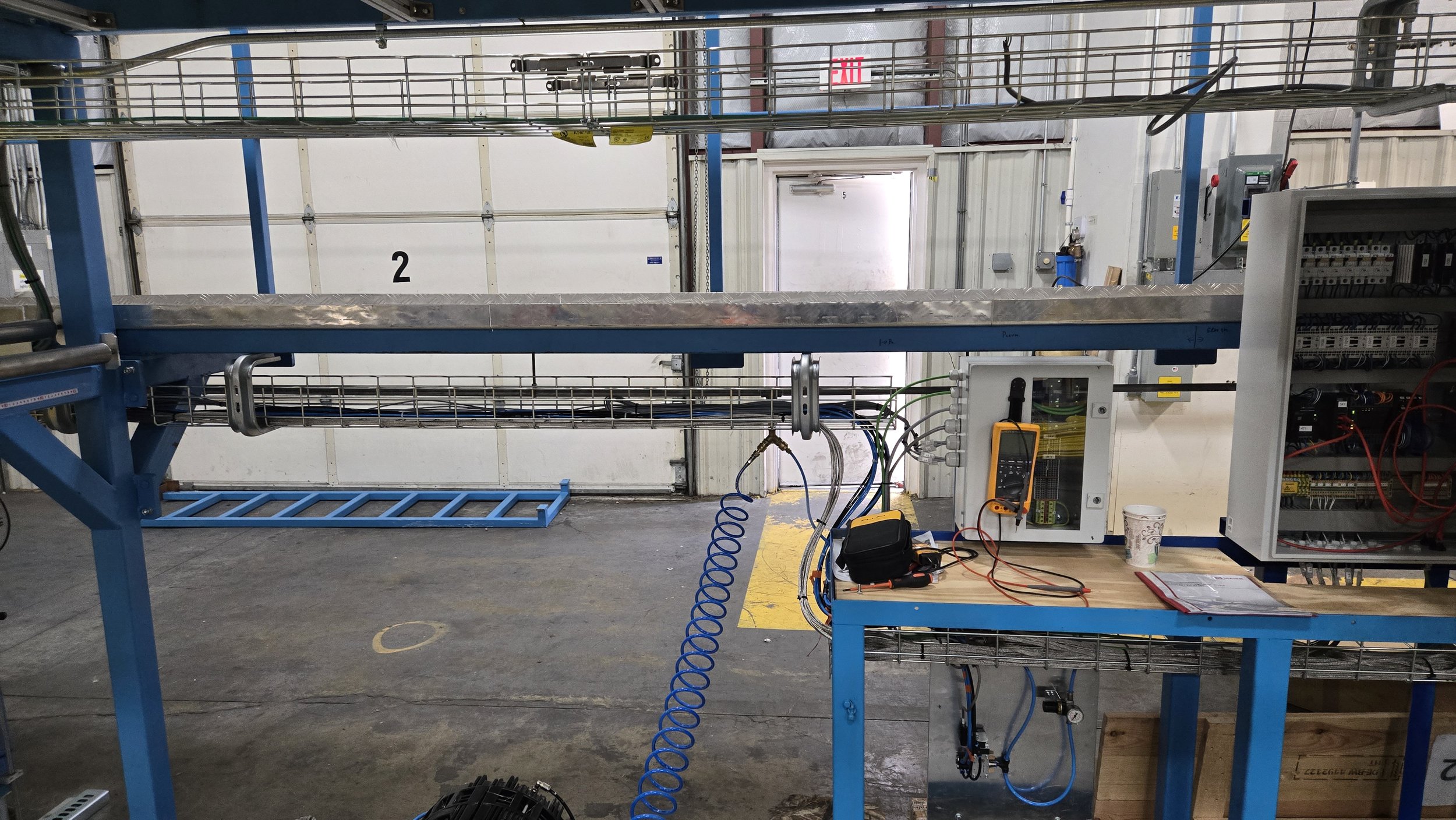 Cable tray for connections to smaller PLC enclosures.  Conduit running above delivering power.