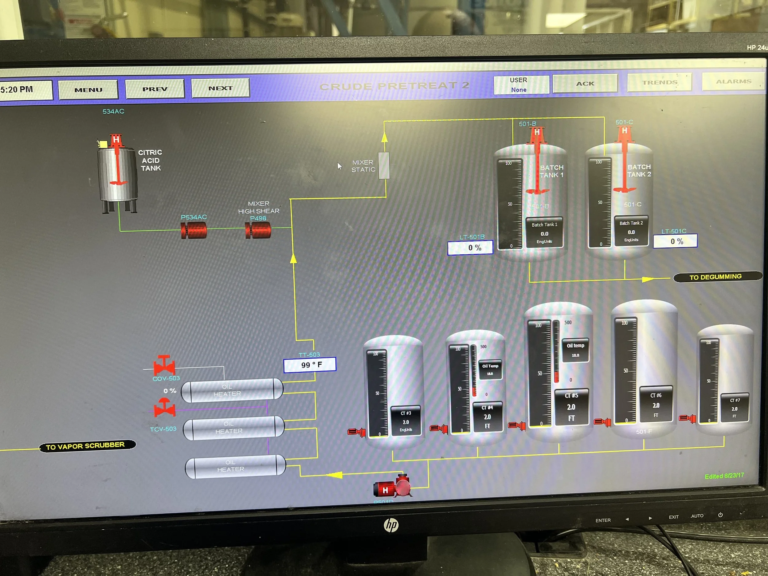 Industrial process control screen with tanks, gauges, and pipelines for chemical or oil management.