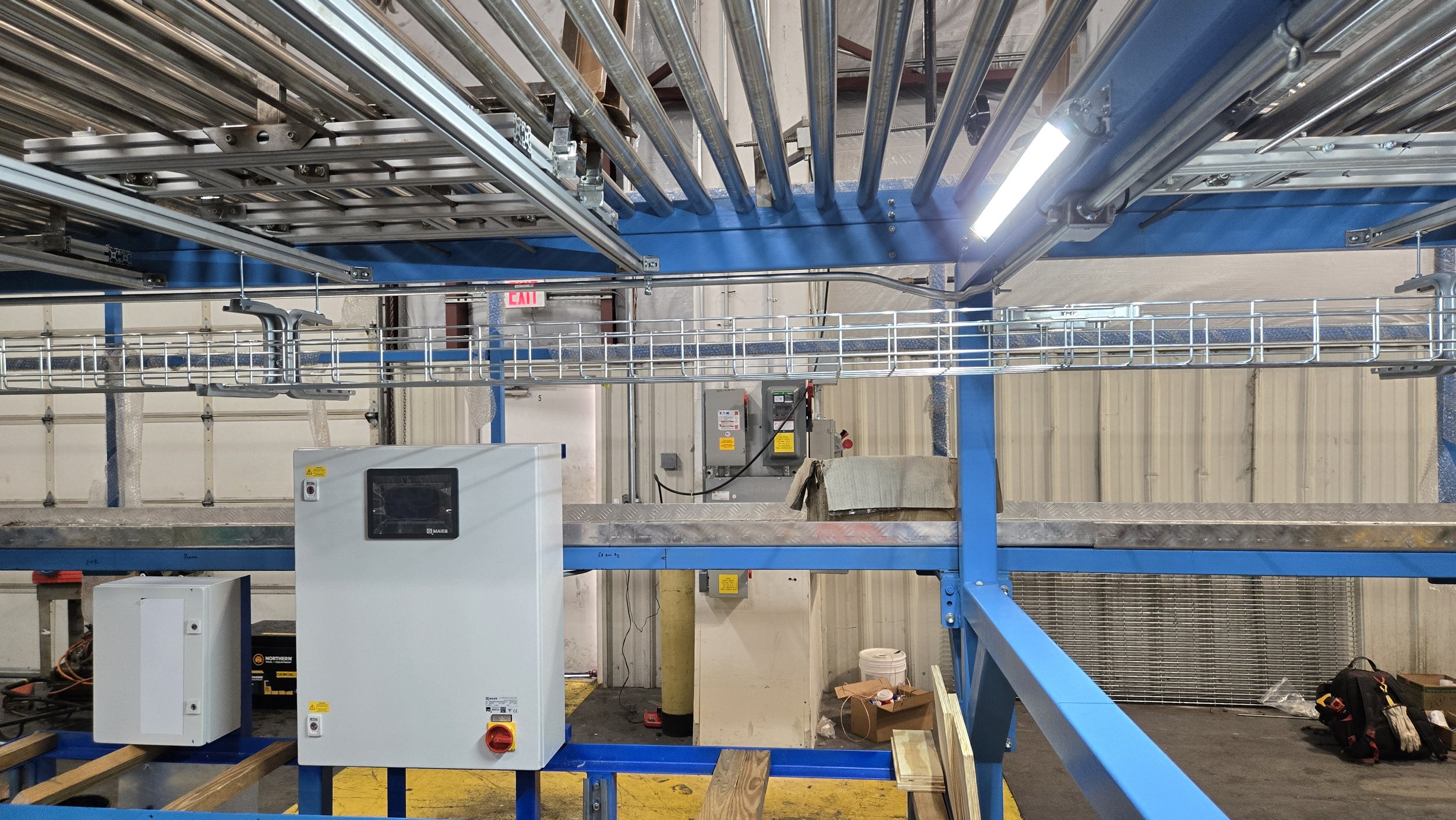 Conduit delivering power to one of several LED light bars installed, on/off switch box installed on beam (out of frame)