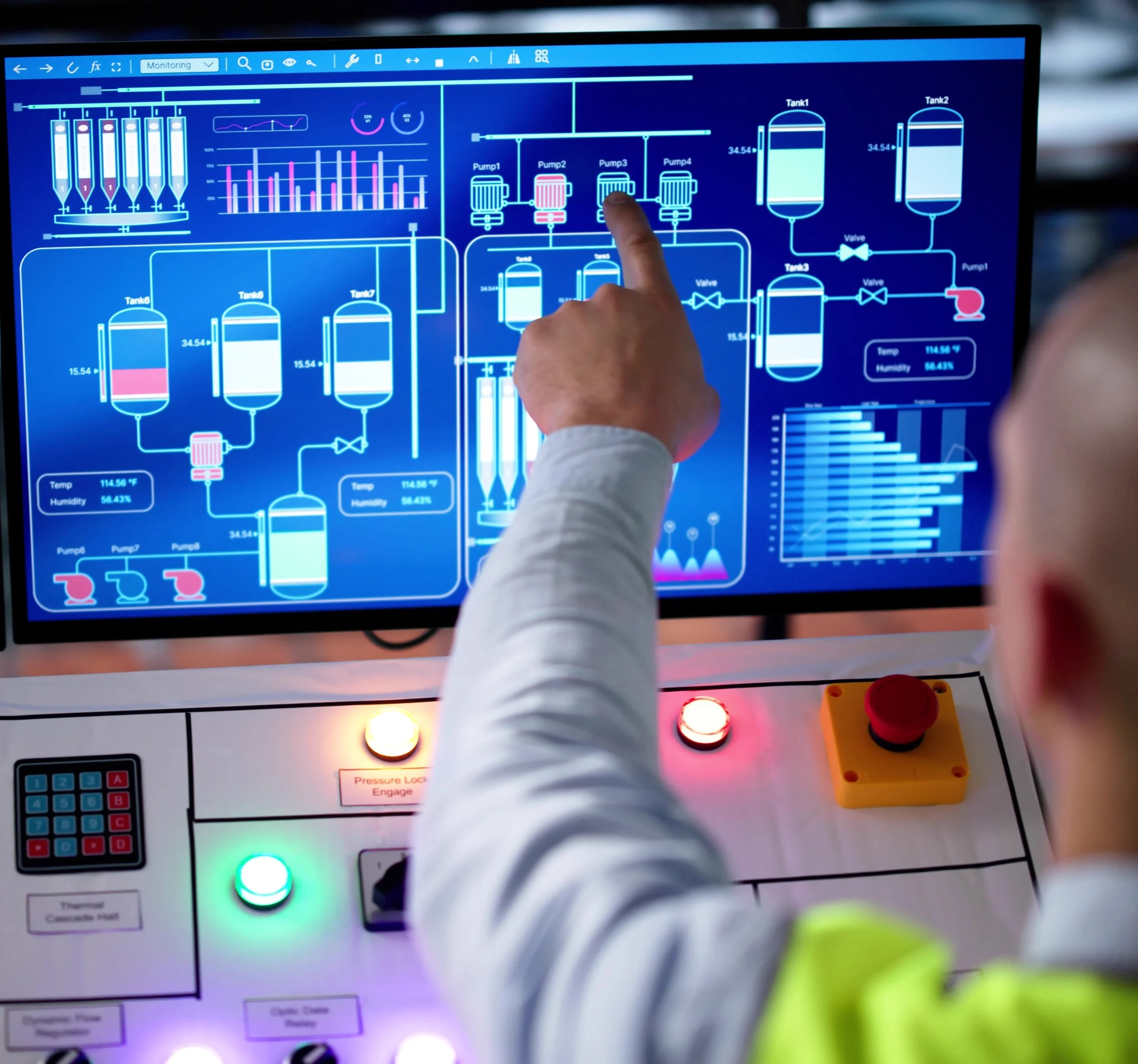Person pointing at a digital control panel with graphs and diagrams related to industrial process management.