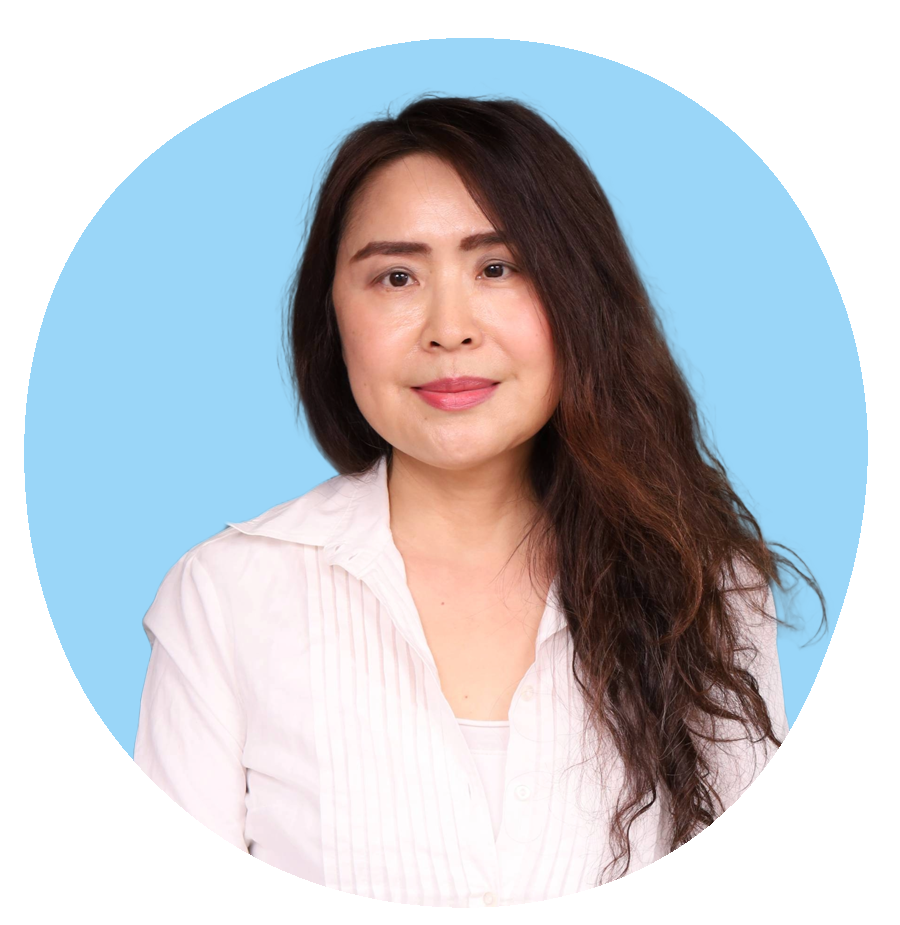 Studio portrait of Nicole Meng, therapist at Oasis of Hope, wearing a white blouse with a soft blue background.