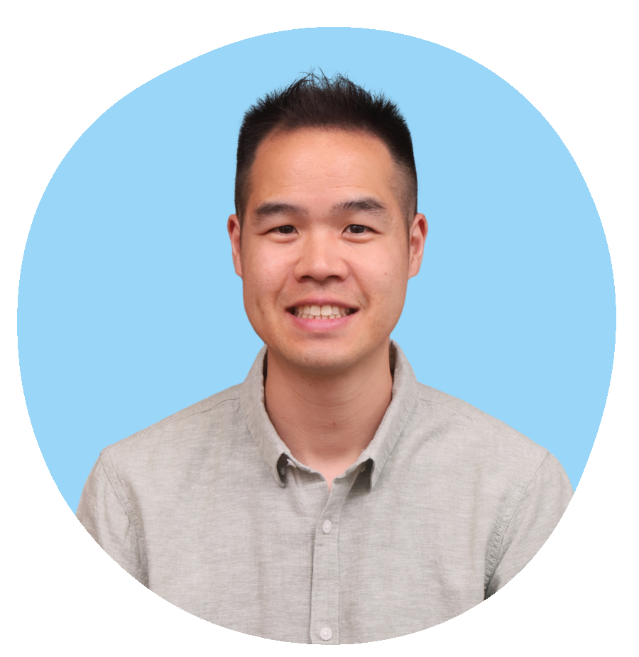 Portrait of a smiling man, founder of Oasis of Hope, Calvin Lam, with short black hair wearing a light grey button-up shirt against a modern blue abstract background.