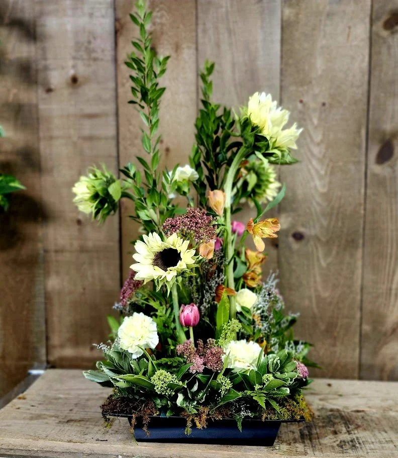 Sunflowers, tulips, and various greenery