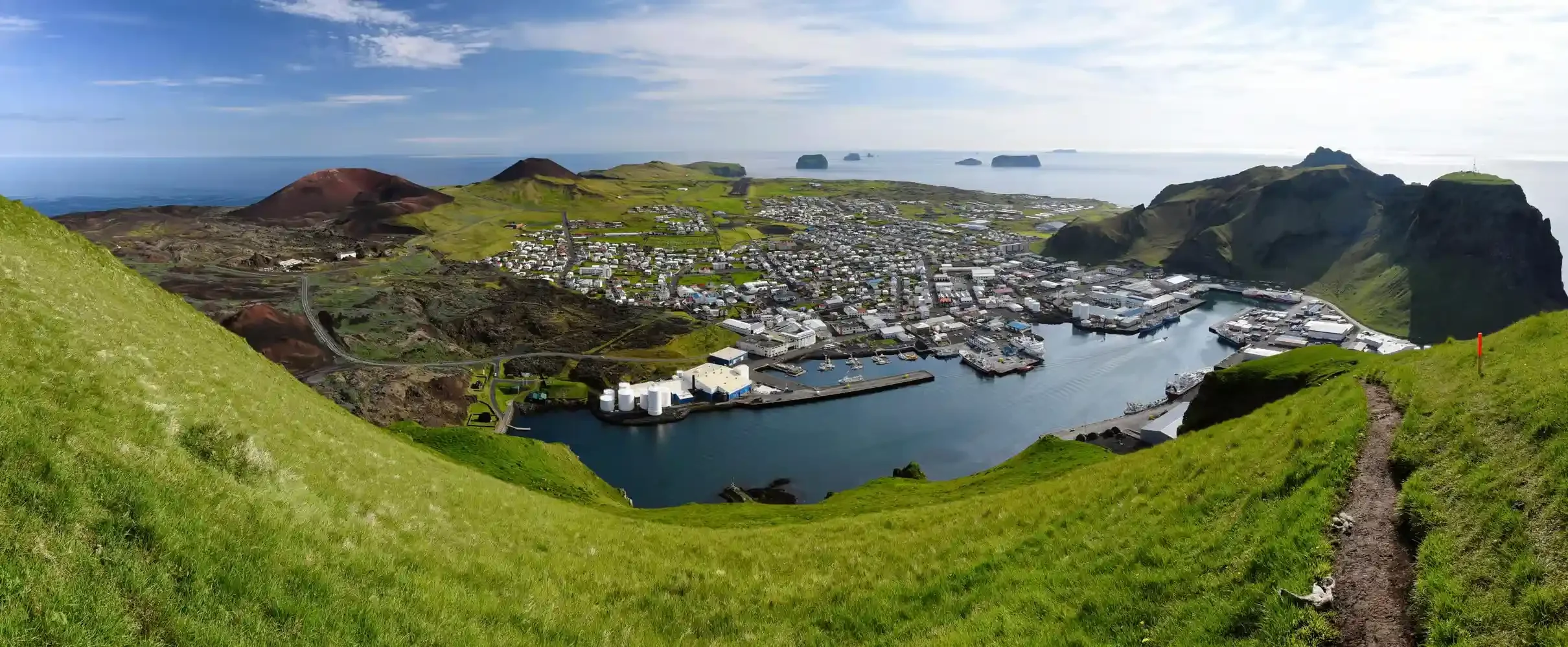 Vue aérienne de Heimaey, îles Vestmann, avec le cratère de l'Eldfell et le port, en Islande