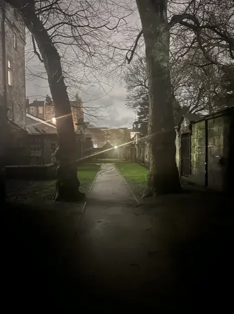 Allée nocturne du cimetière de Greyfriars à Édimbourg, lieu hanté par le poltergeist de Bloody MacKenzie