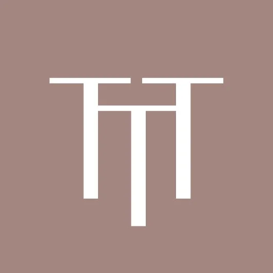 Abstract white geometric symbol on a beige background.