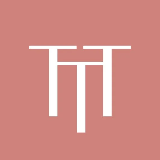 White abstract geometric symbol on a pink background.