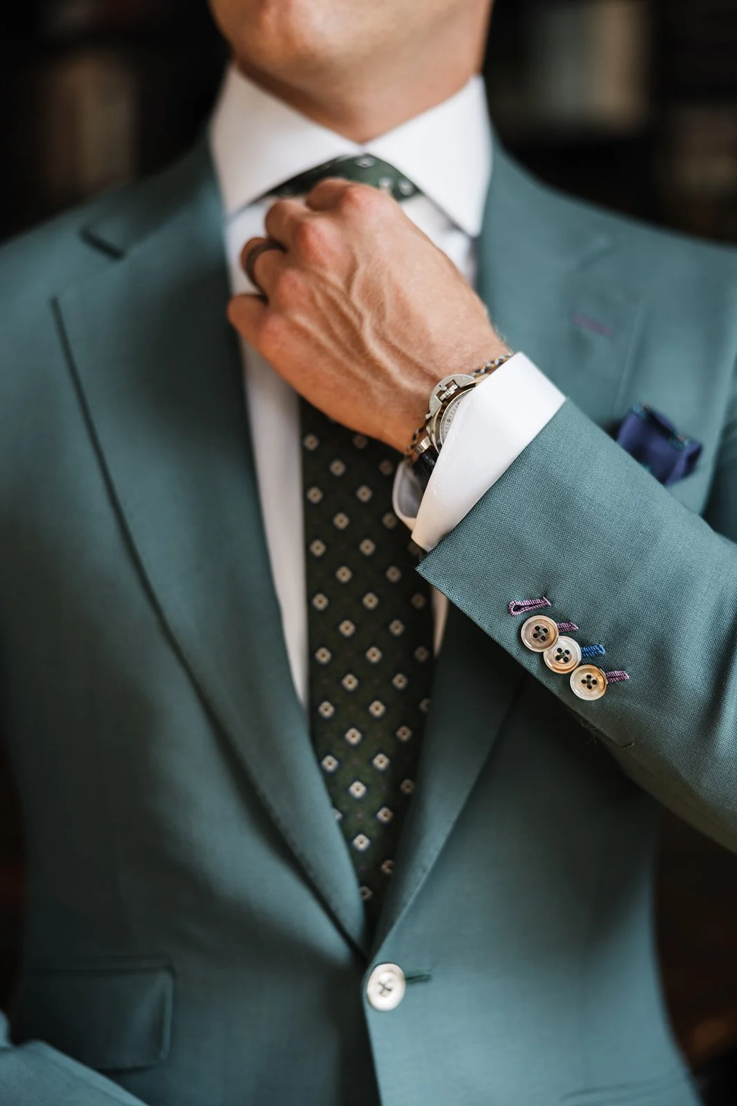 green suit with functional cuff buttonholes