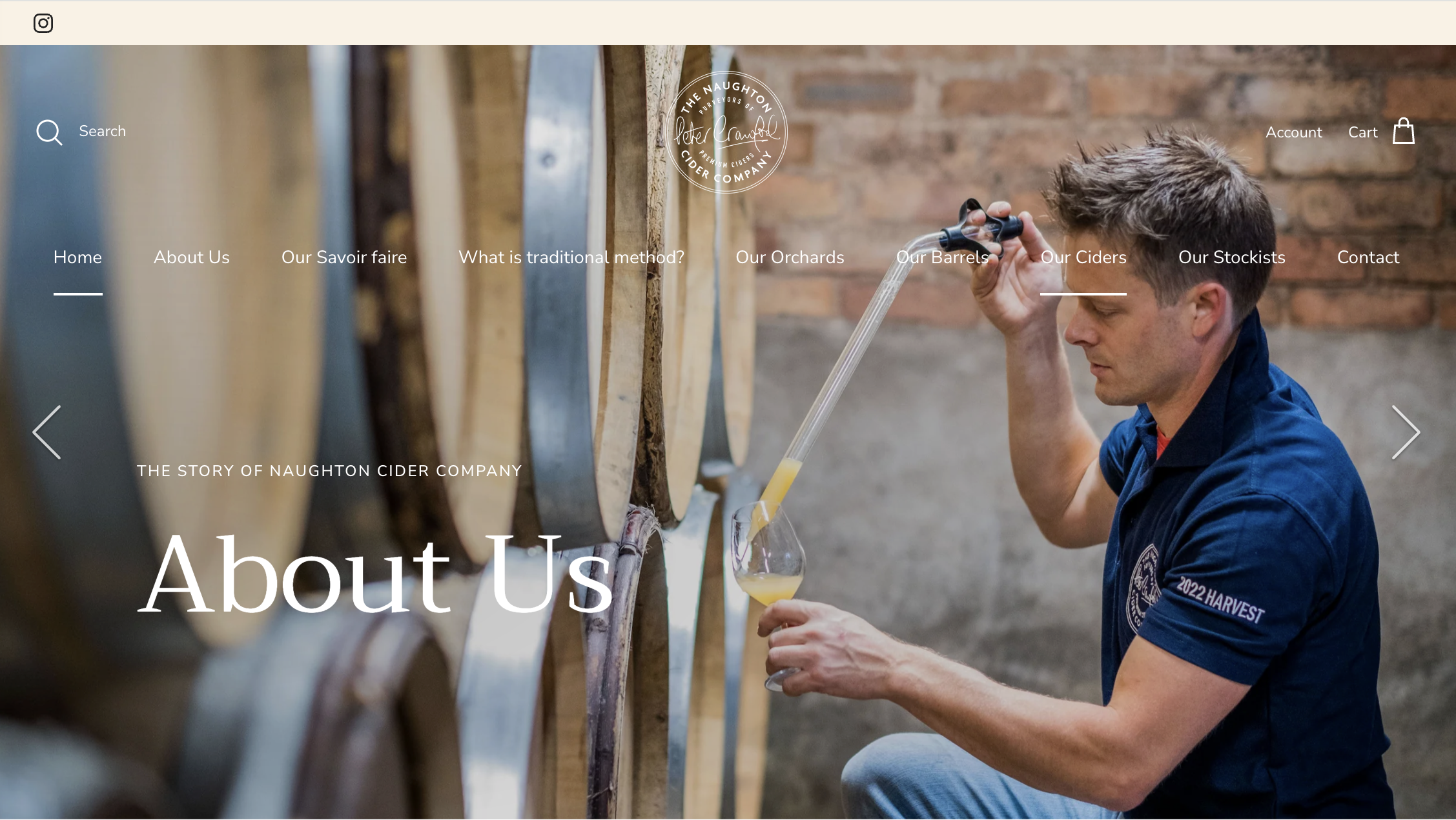 Man filling a wine glass from a wooden barrel at a cidery, with the cidery's logo and navigation menu overlaid.