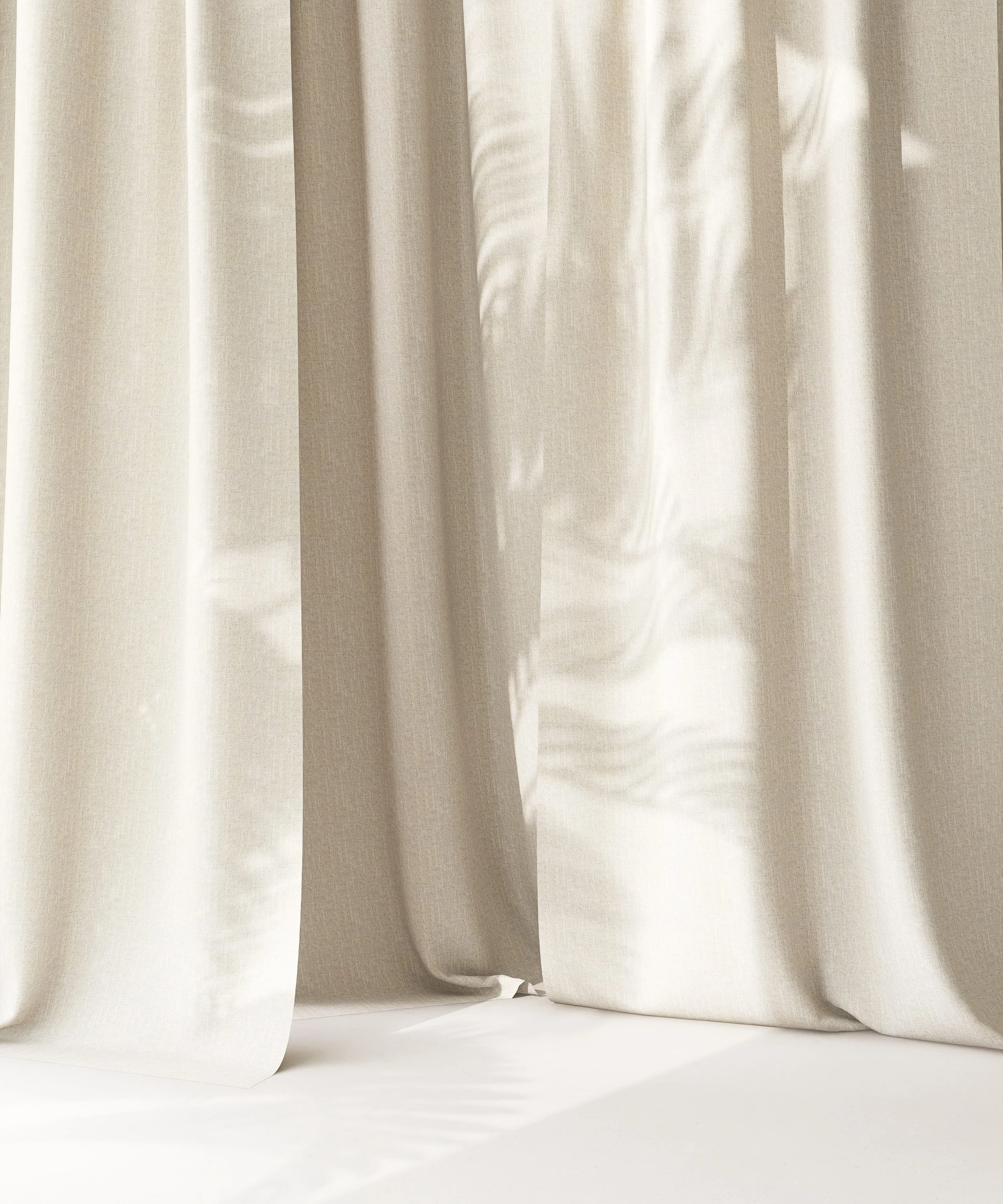 Cream-colored curtains hanging against a white background, with light creating soft shadows.