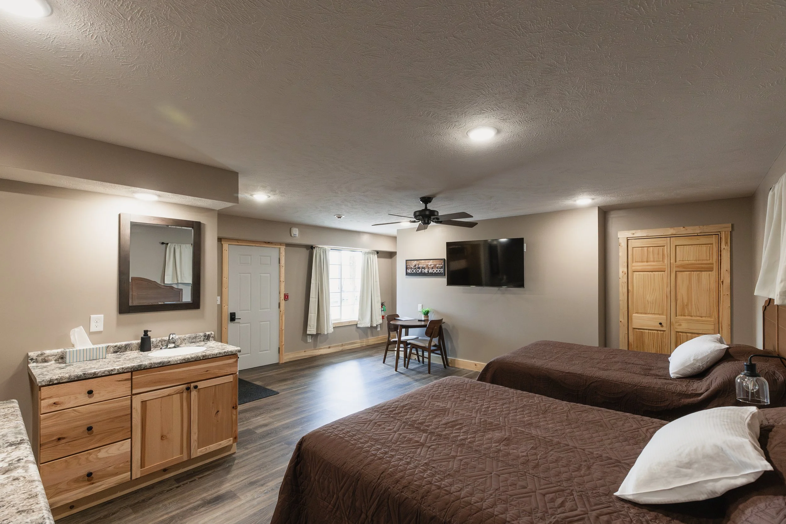 Interior of Stockman's Lodge room with beds, seating area, and sink.