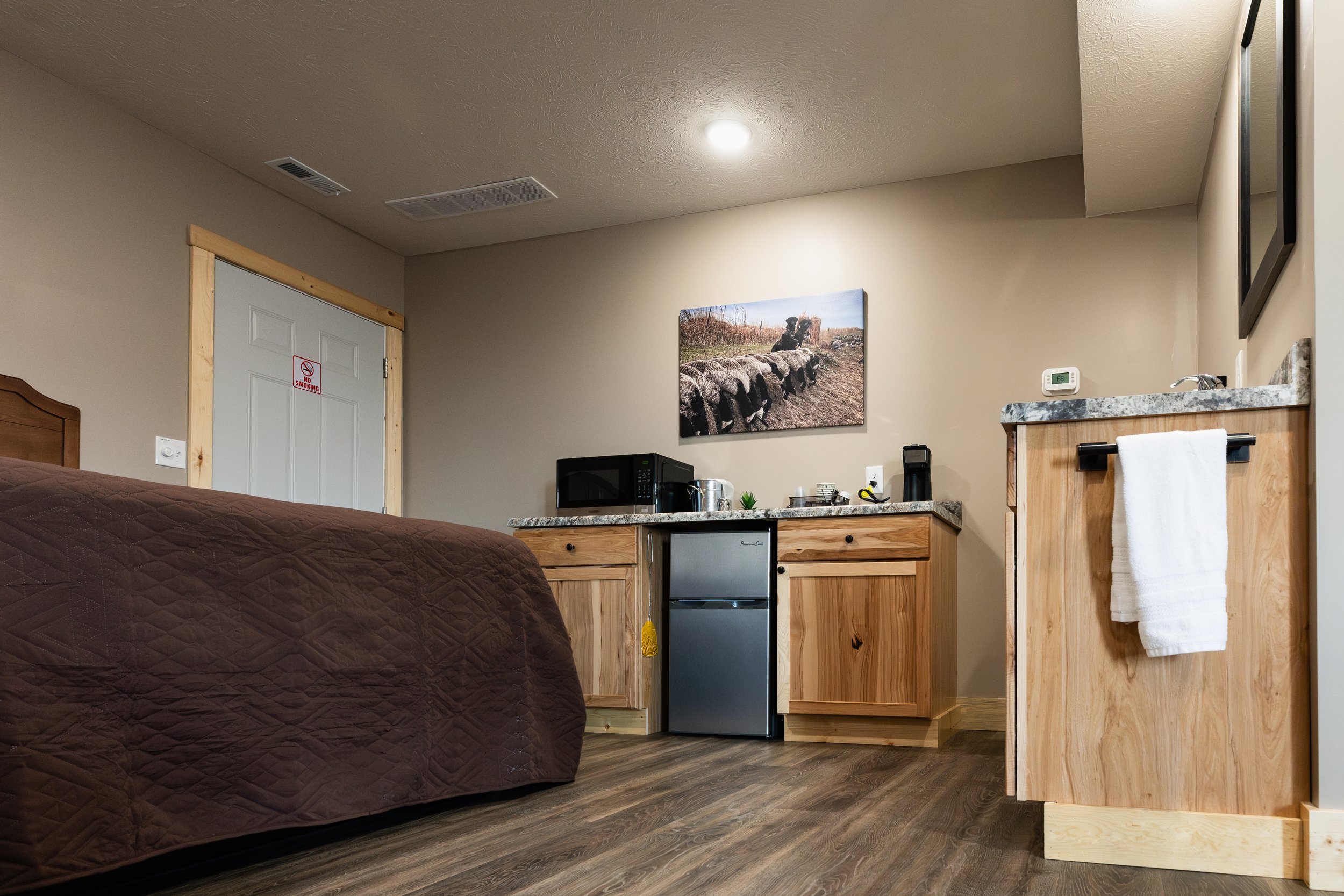 Kitchenette area with microwave, mini fridge, and coffee maker inside of a room at Stockman's Lodge.