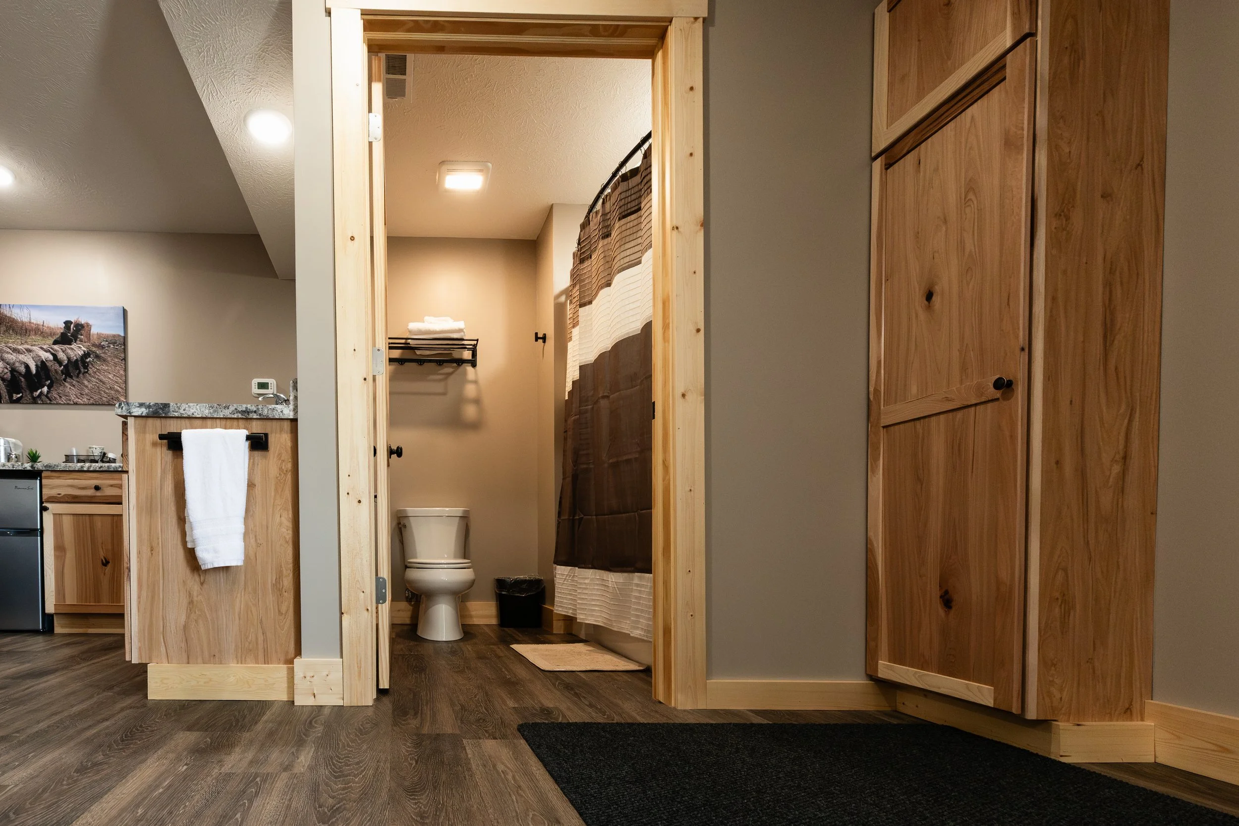 Bathroom inside of a room at Stockman's Lodge with a toilet and shower bathtub combination..