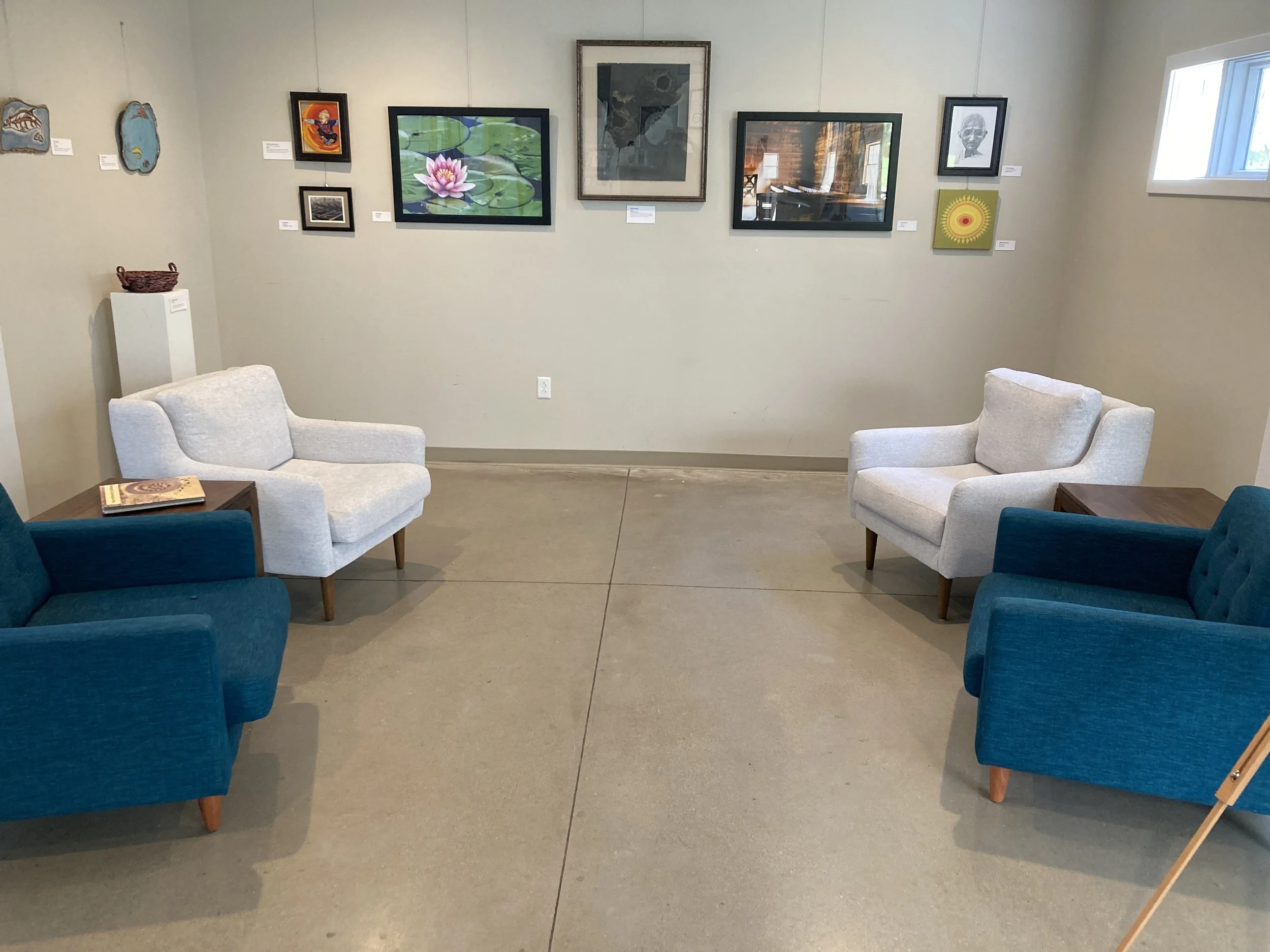 Arth Show 2025 Narthex chairs with paintings.jpg