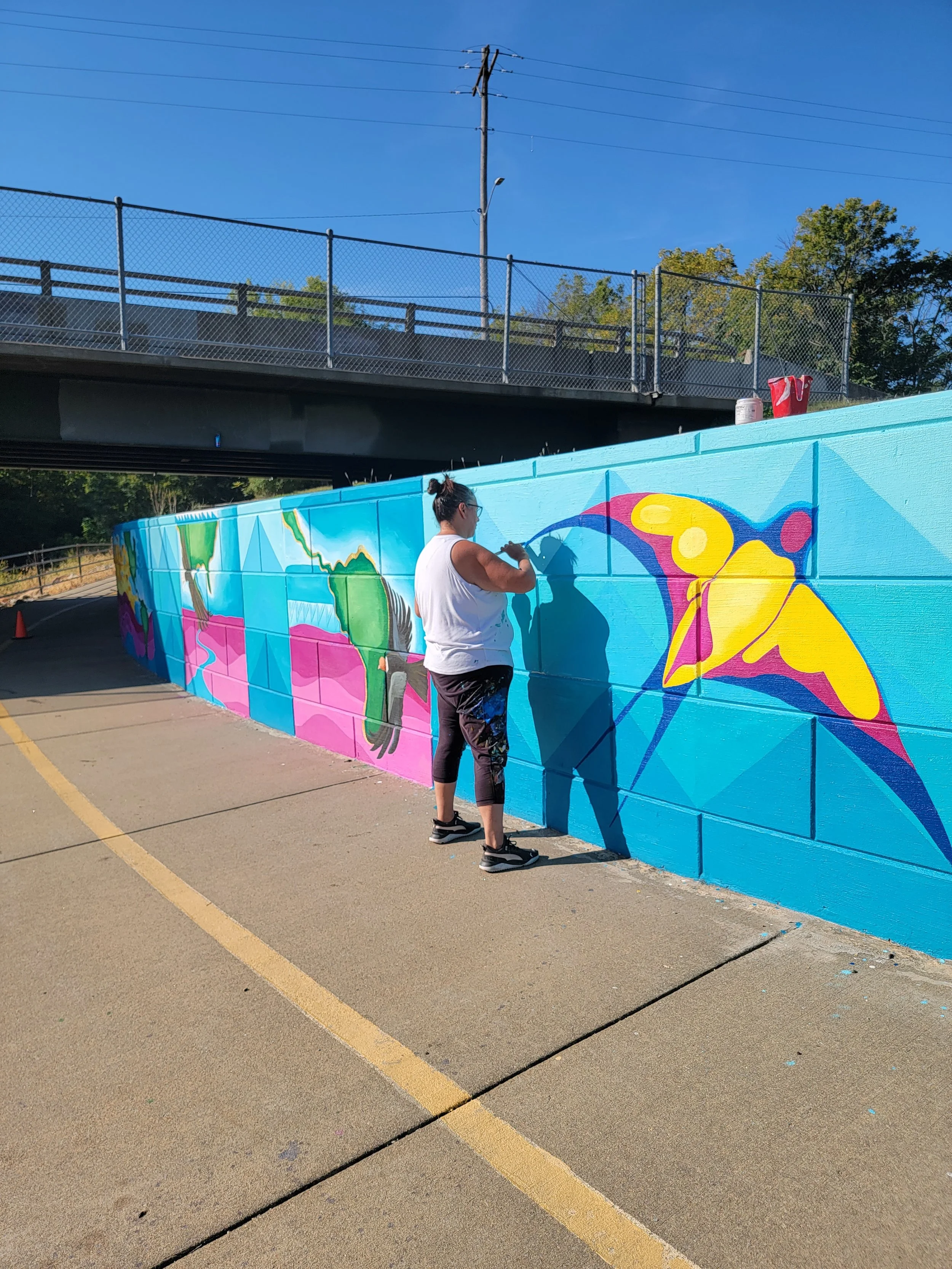 Mona Cliff painting the wall