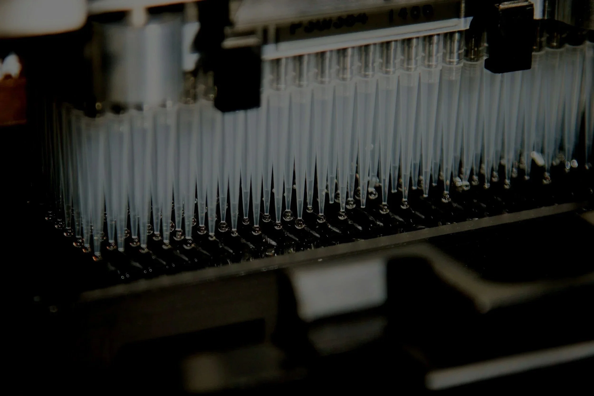 Close-up view of a laboratory instrument with a rack of small test tubes or vials, possibly for scientific or medical testing.