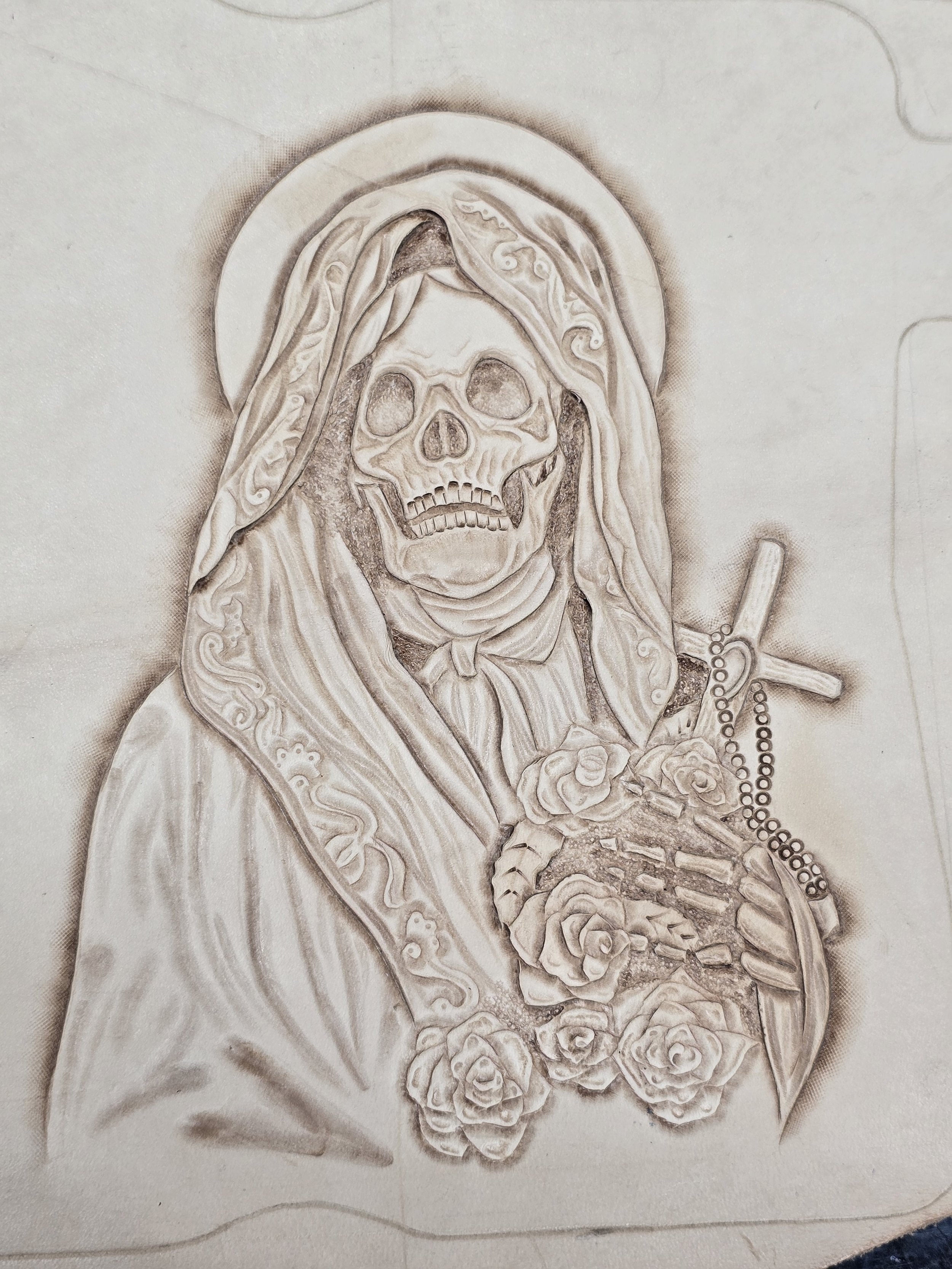A detailed black and white sketch of a skeleton with a skull, draped in a religious veil, holding a rosary with a cross, and surrounded by roses.