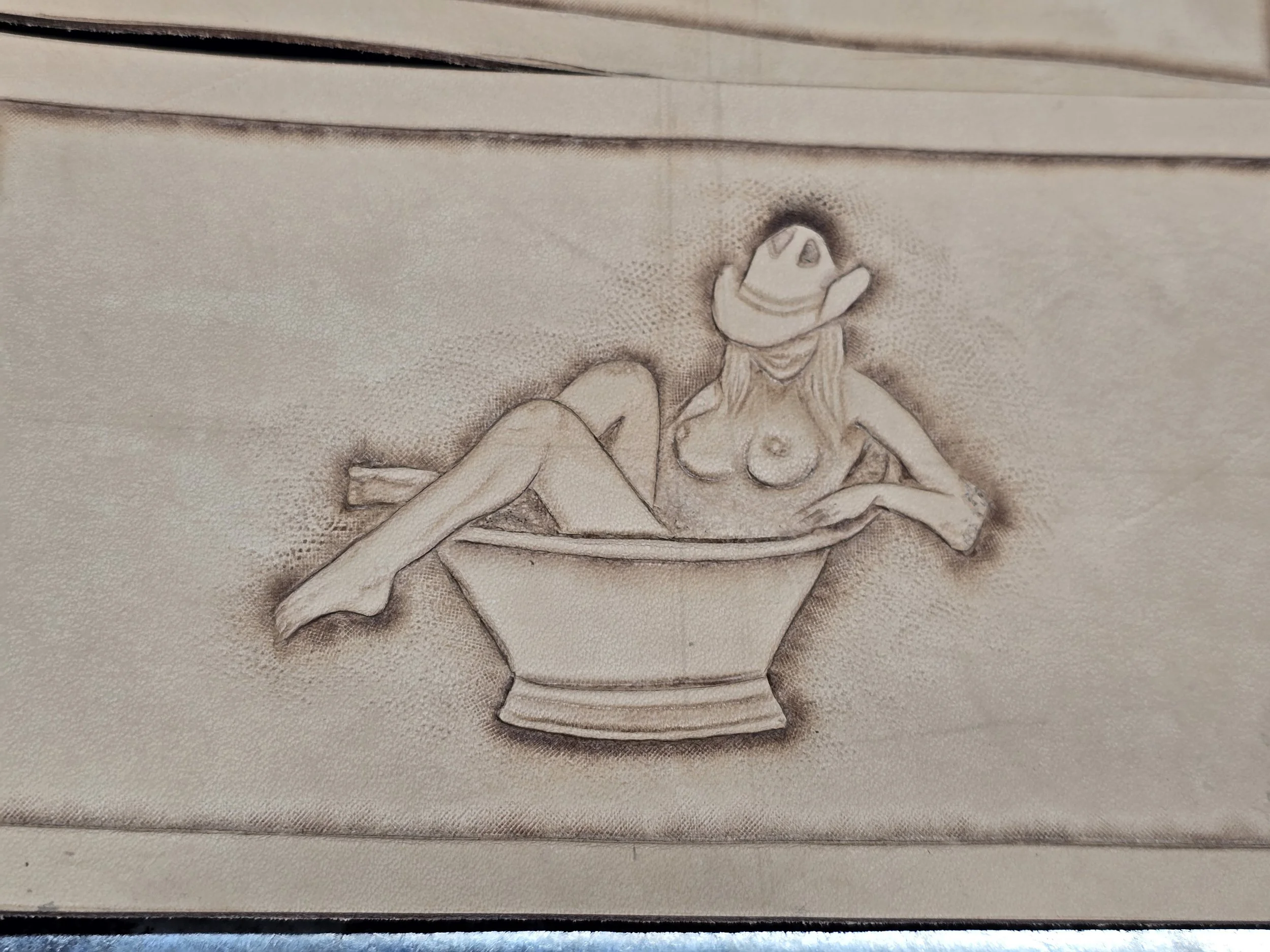 A drawing of a woman with a cowboy hat and long hair, sitting inside a large bowl or dish.