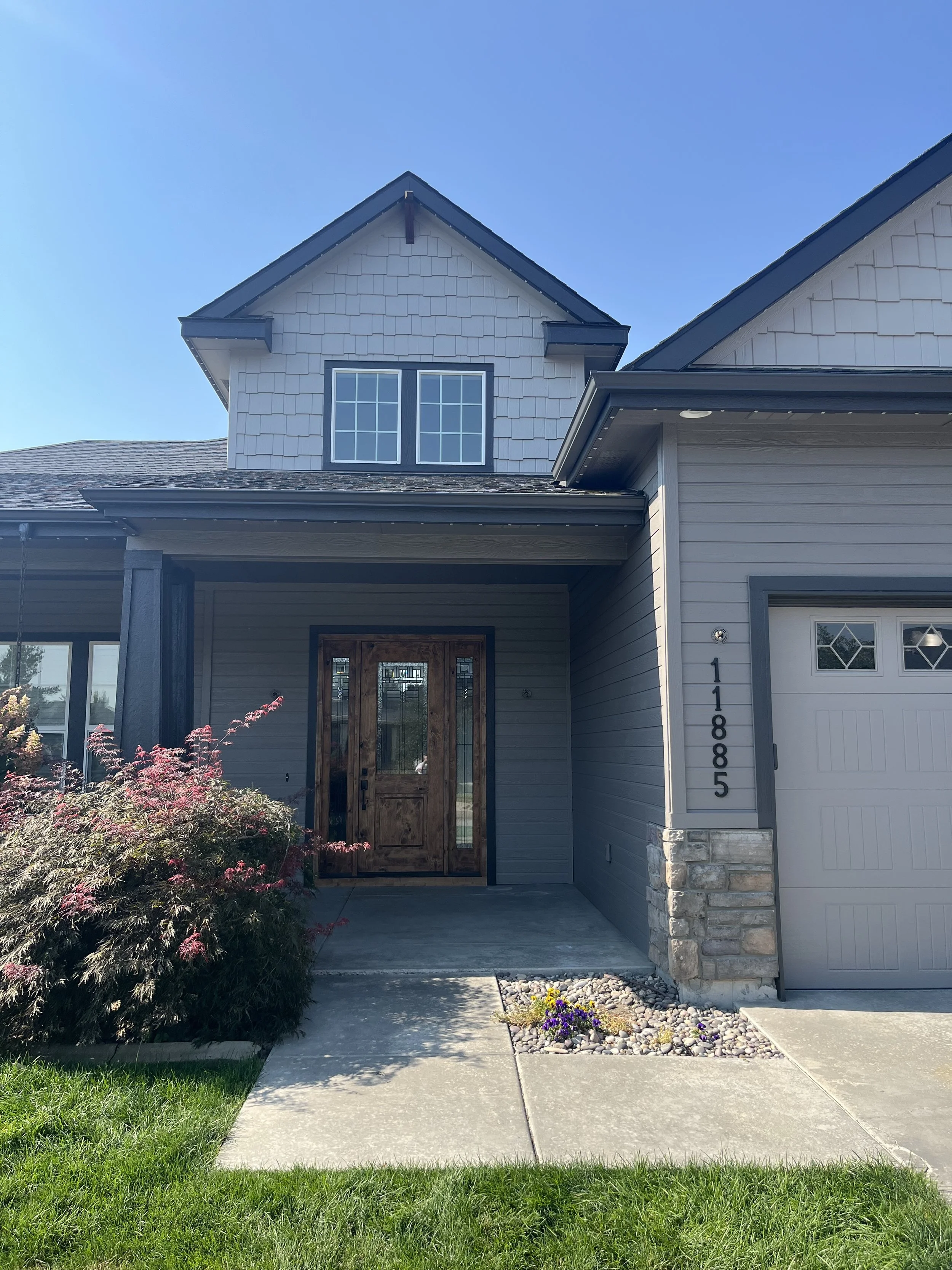 From brown and sun damaged we gave this home a face lift with a two tone gray body and black fascia color scheme.