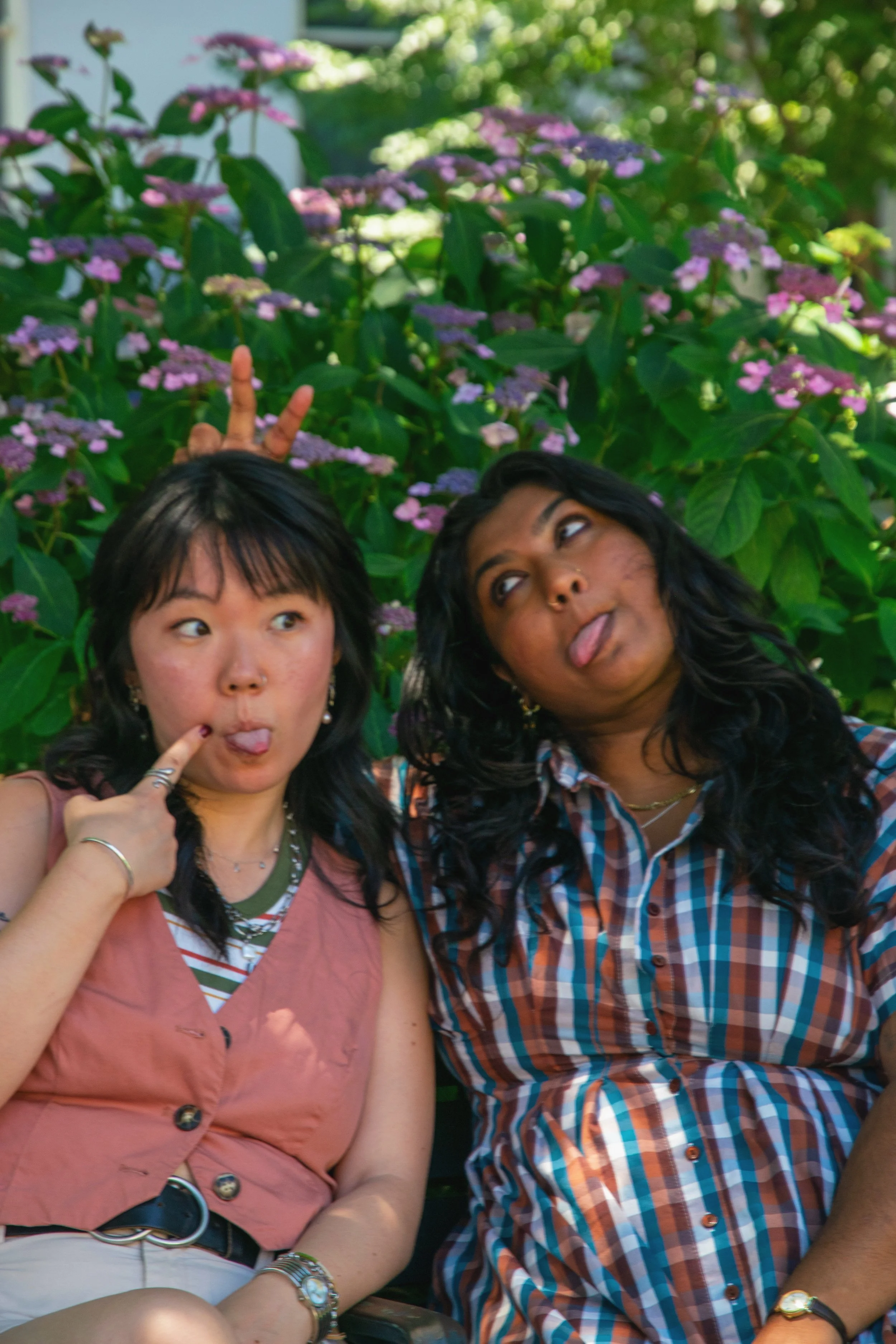 Two warm and affirming queer therapists in Baltimore, Maryland being silly together outside.