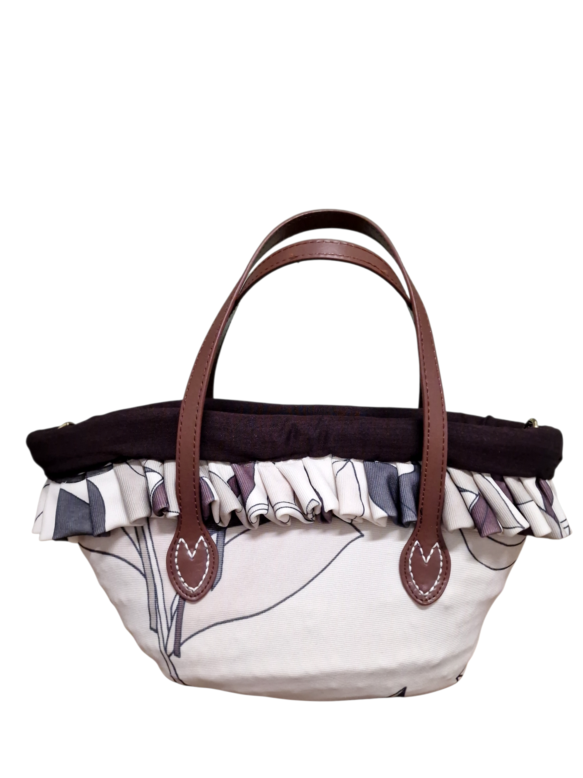 Immagine laterale della coffetta Cefalù Ammuri che mostra forma, bordo in tessuto e manici in pelle marrone.