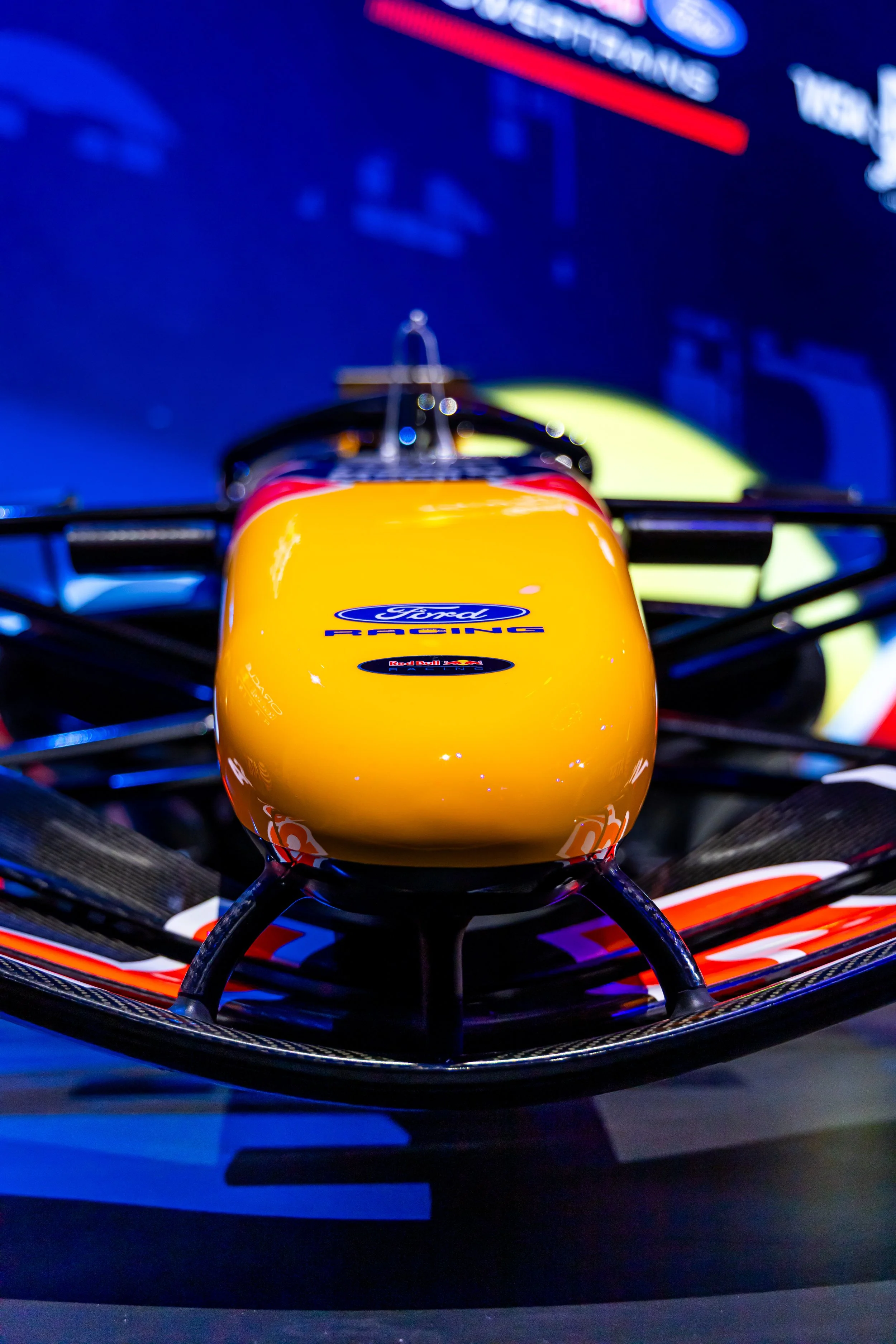 Close-up of a Formula 1 racing car's front nose, showing sponsor logos including Ford and Red Bull