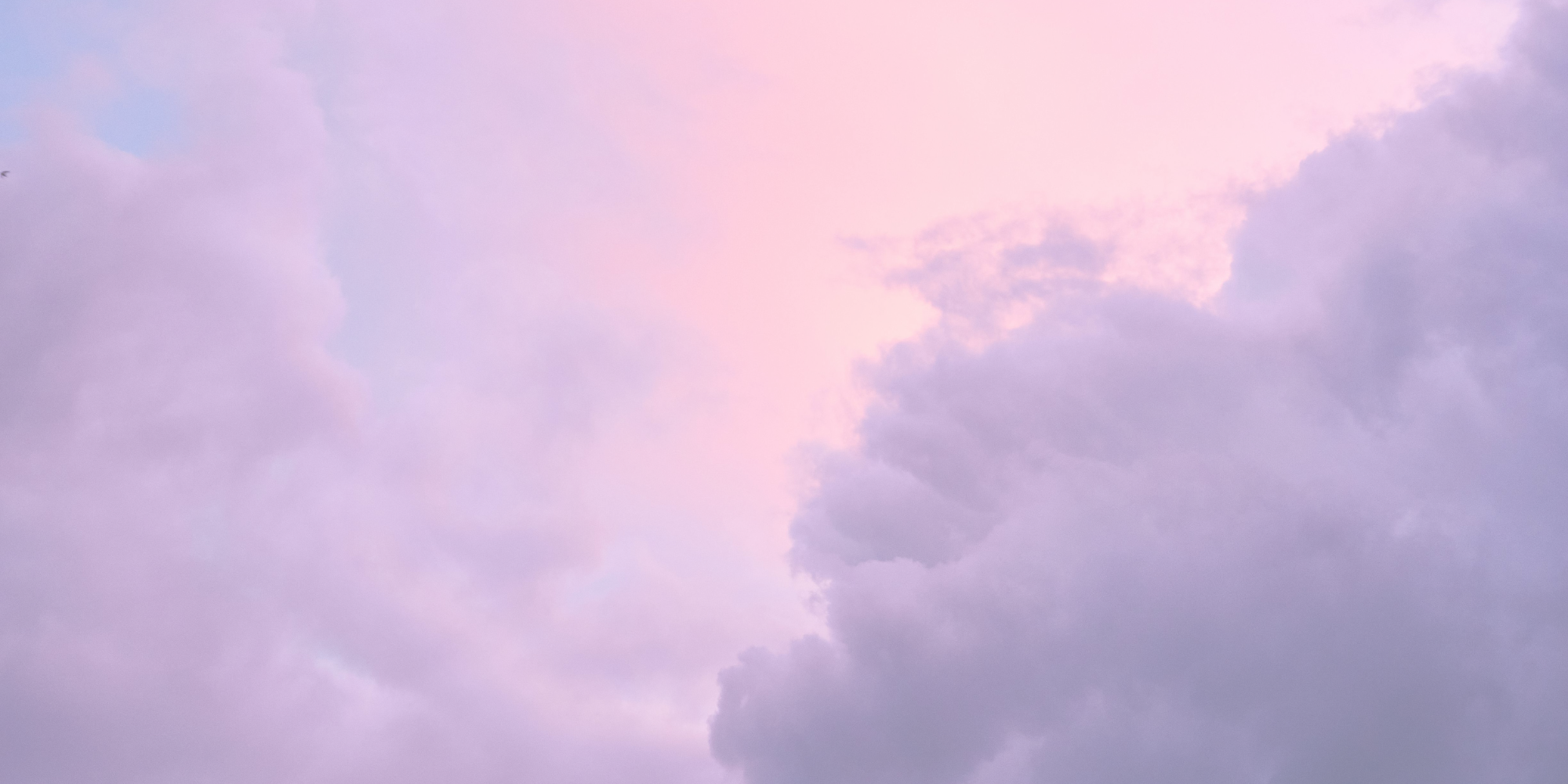 Pink and purple cloudy sky during sunset or sunrise.