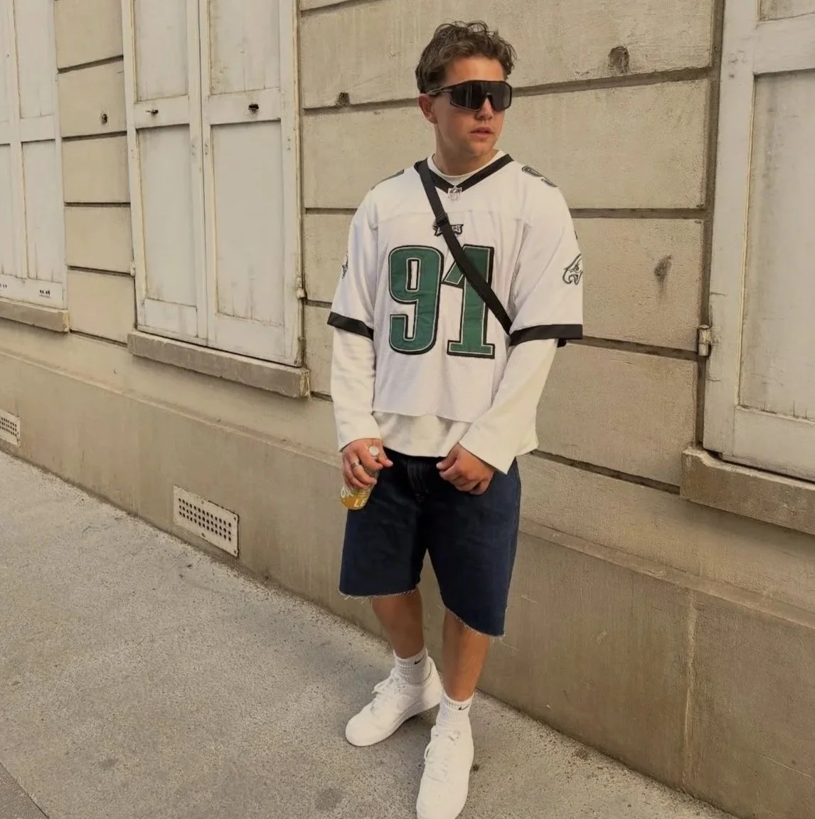 White British man with sunglasses posing in a swaggy outfit