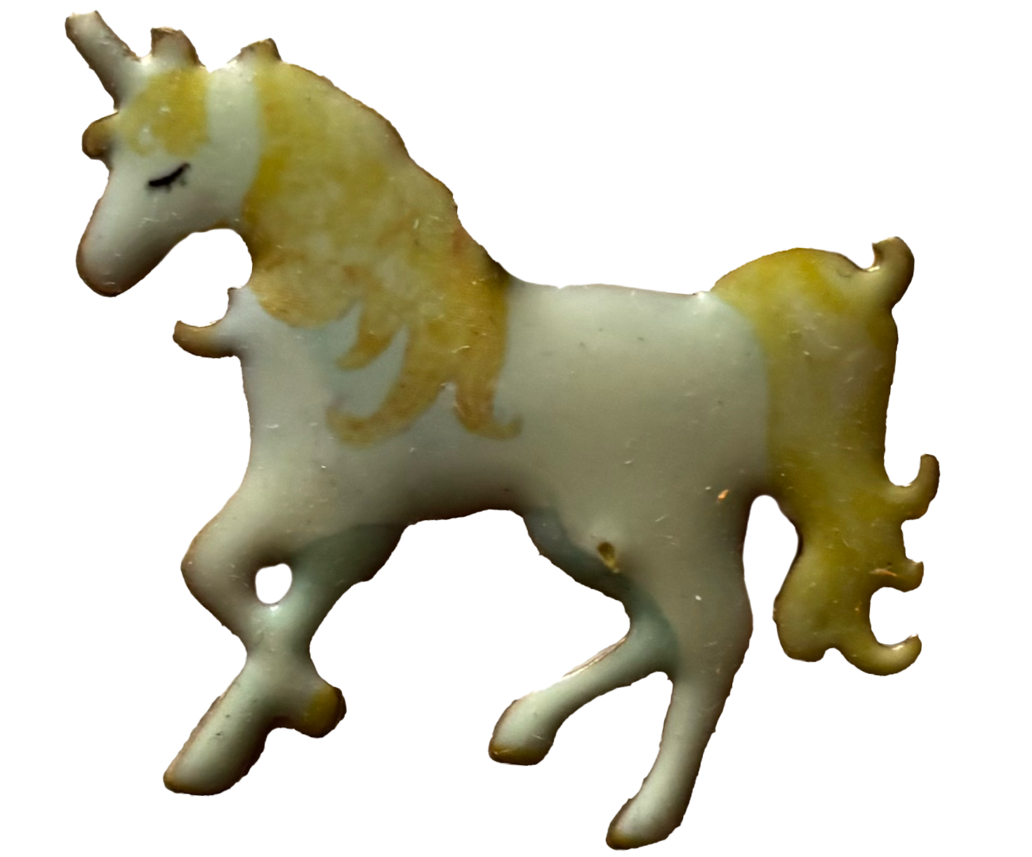 A cookie shaped like a unicorn with white and yellow icing.