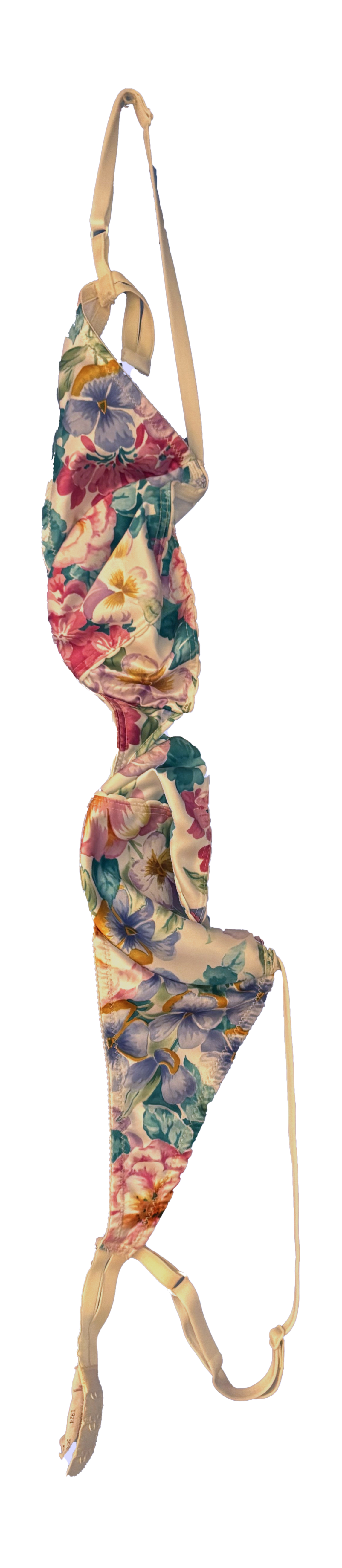 A floral bra with pink, purple, yellow, and green flowers on a beige background.