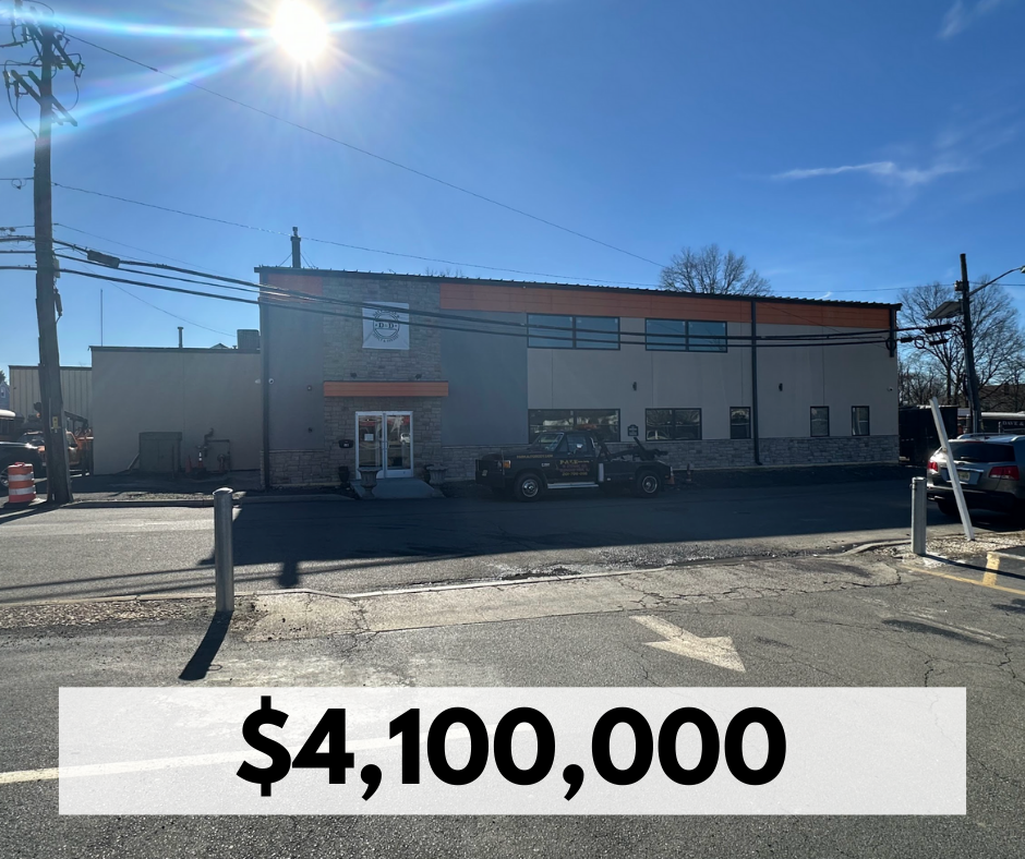 A commercial building on a sunny day with a parking lot in front, a police vehicle parked near the entrance, and the price $4,100,000 displayed at the bottom of the image.