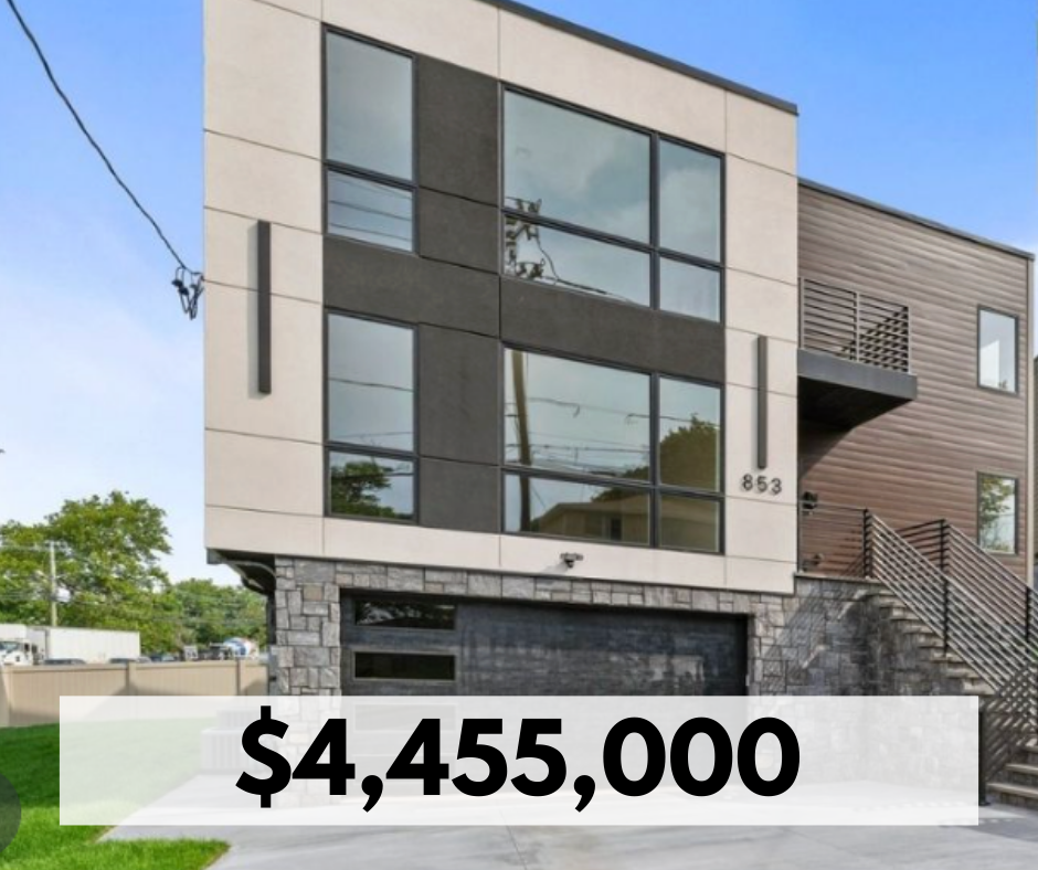 Modern multi-story house with large glass windows, a stone foundation, and a wooden exterior section, located at 853.