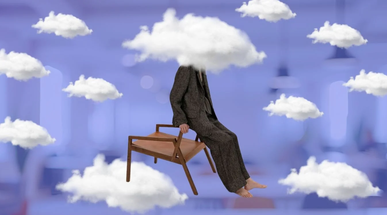 person resting against chair with head in the clouds
