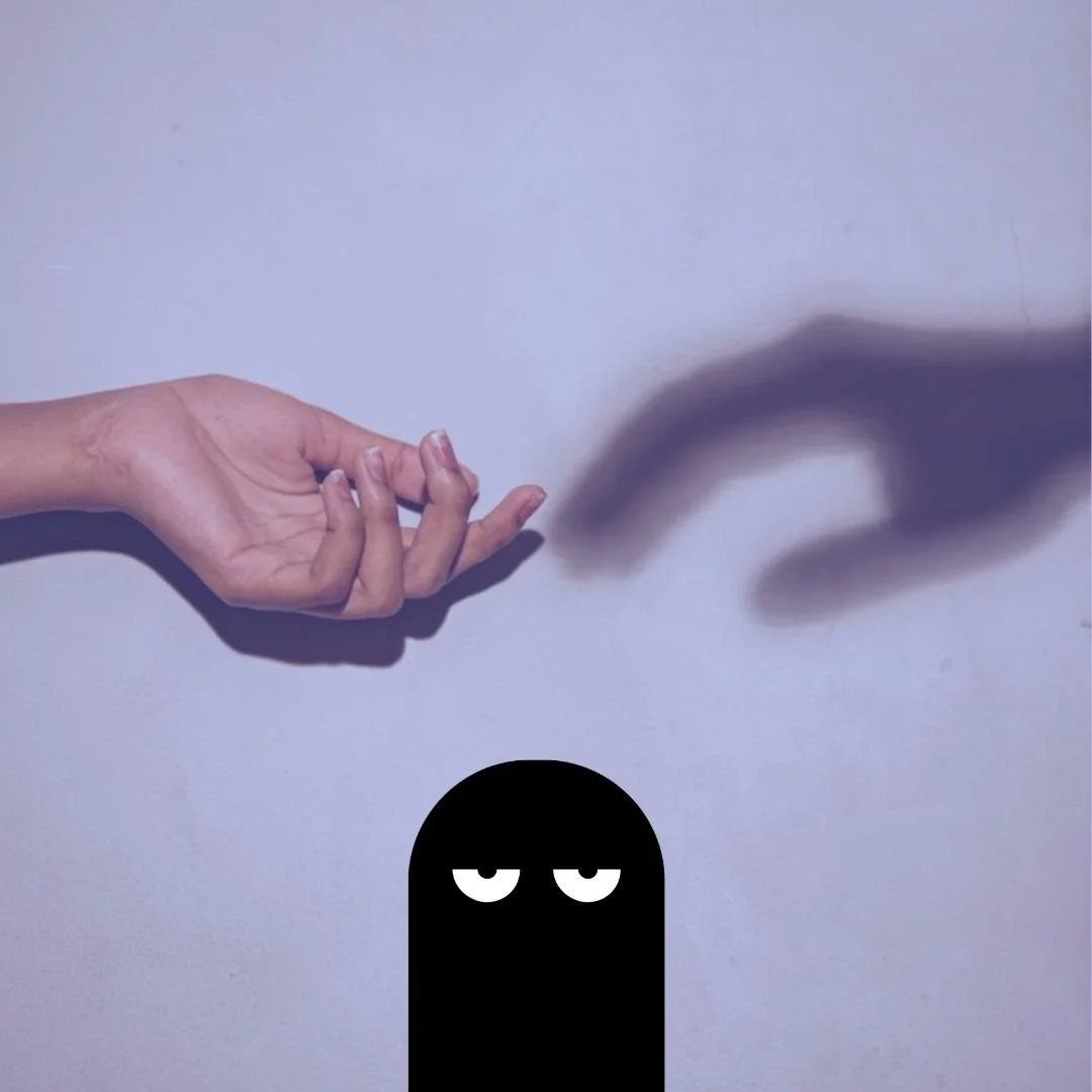 A hand reaching out to a shadow hand with an Our Kind Therapy cartoon logo figure beneath