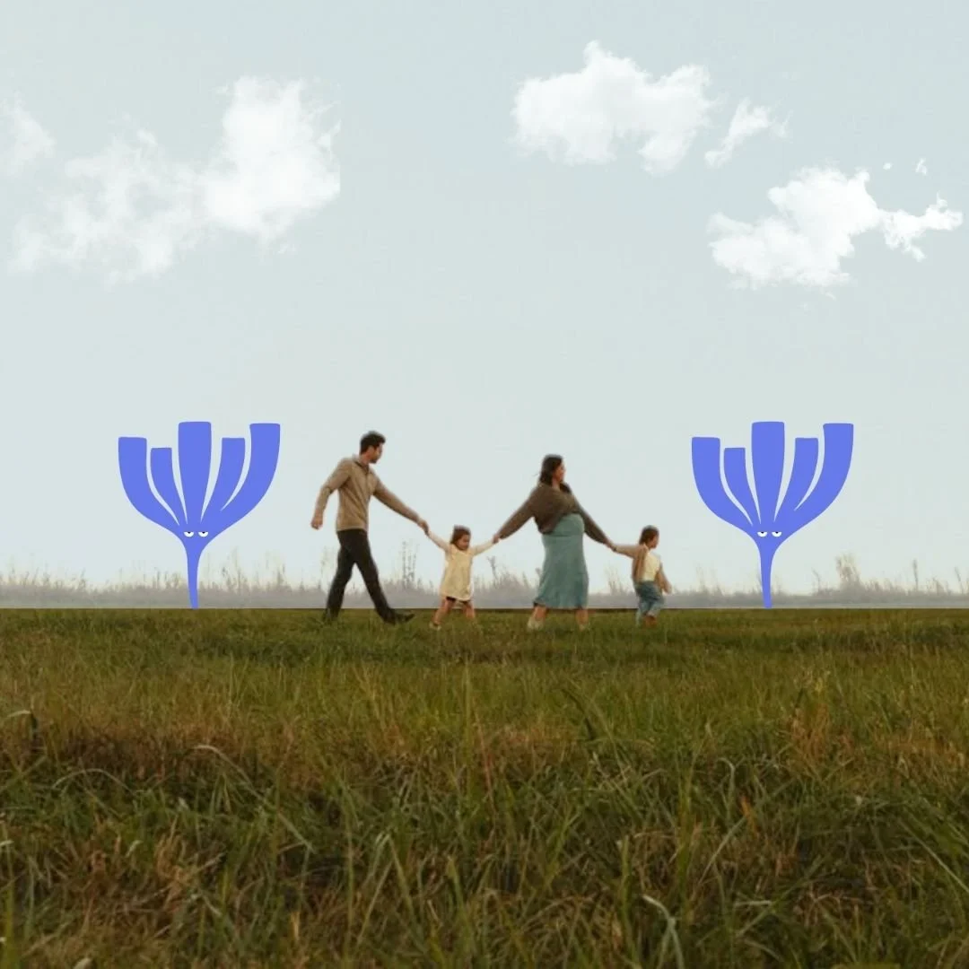 Man, child, pregnant woman, and another child holding hands walking in a line in a grass field with Our Kind Therapy cartoon logo images