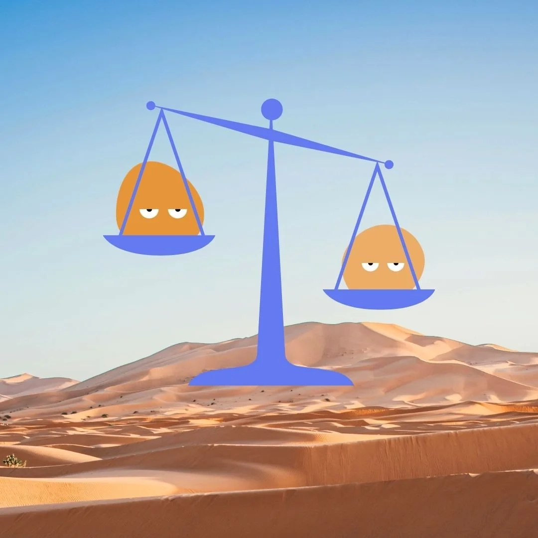 A scale balancing two Our Kind Therapy cartoon logo figures in the desert